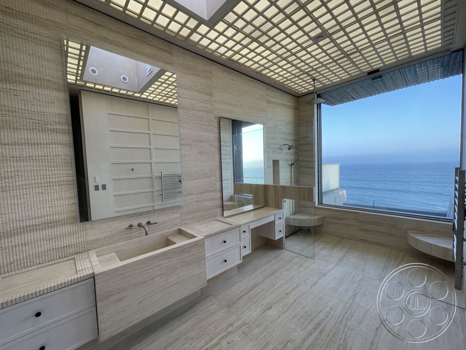 Modern 509 - interior neutral color palette, exterior modern architectural style, interior minimalist design, interior soft ambient lighting, exterior oceanfront property, interior marble bathroom flooring, interior textured stone wall, interior glass shower partition, interior built-in vanity with white cabinetry, interior floor-to-ceiling windows with ocean view, interior coffered ceiling with grid design, interior dual mirrors above vanity, interior seamless glass shower doors
