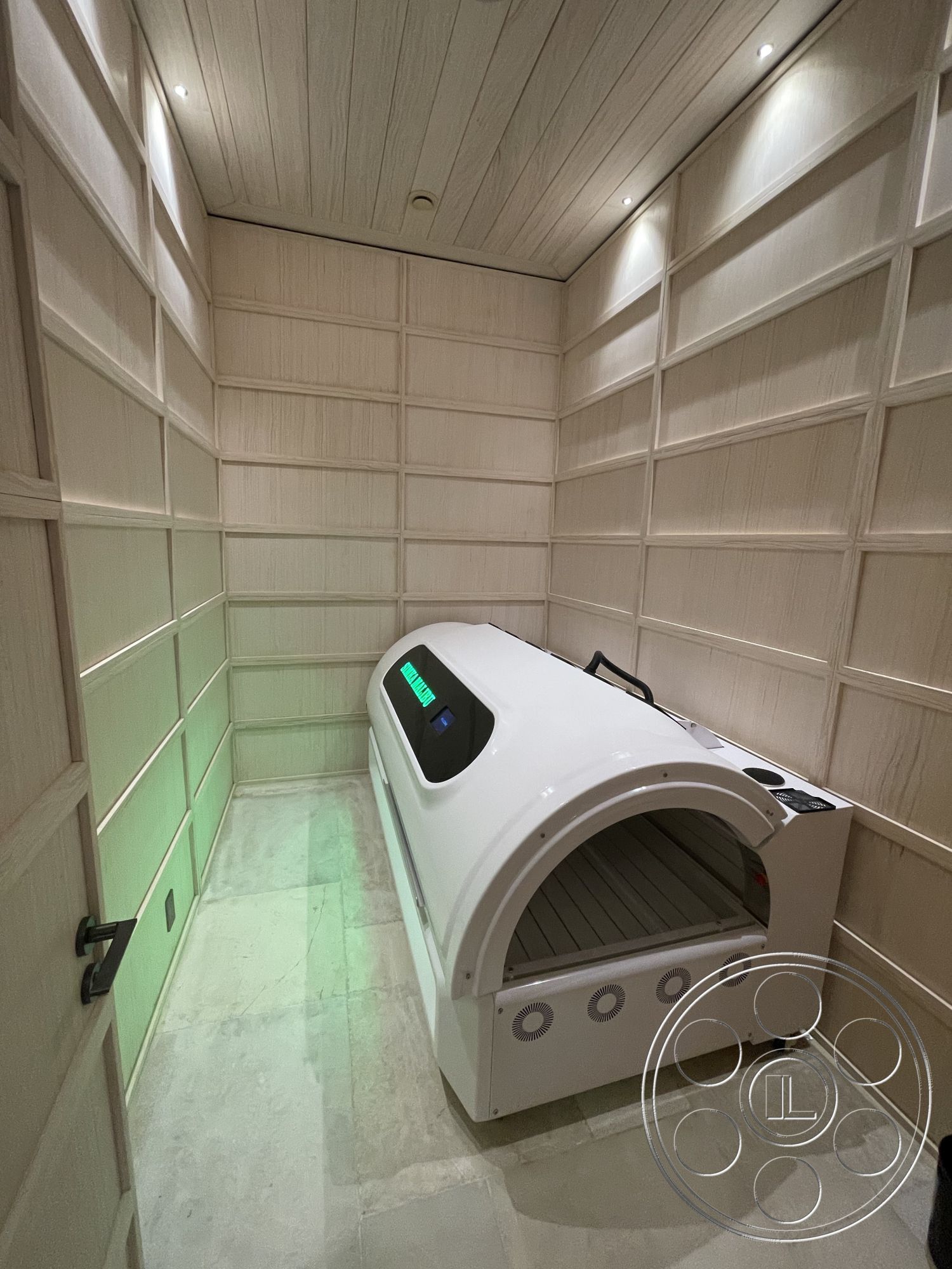 Modern 509 - white wood paneling walls interior, textured plaster ceiling interior, polished stone flooring interior, spa treatment room interior, linear LED lighting fixtures interior, minimalistic design aesthetic interior, closed door with black hardware interior, therapeutic bed unit interior, soft ambient lighting interior