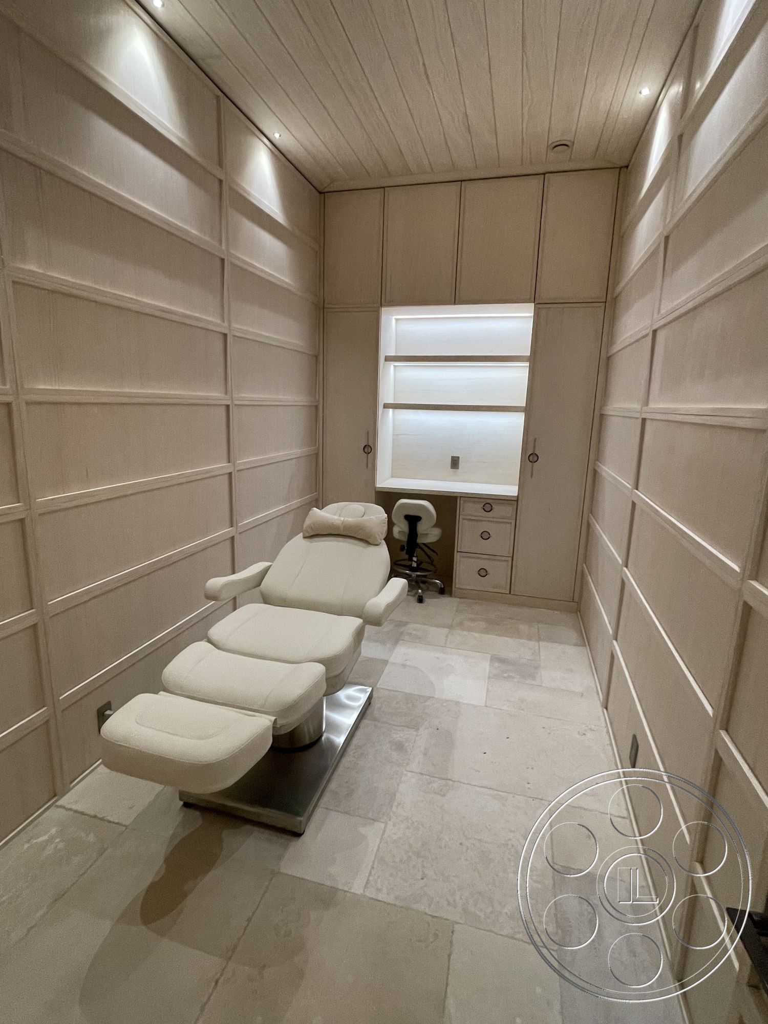 Modern 509 - neutral color palette, natural stone flooring, contemporary interior design, minimalist furniture design, ambient recessed lighting, functional work area, interior spa room, large format stone tiles, panelled wall treatment, light wood ceiling panels, modern spa lounge chair, built-in storage cabinet, calming wellness environment, luxury relaxation space, spa treatment environment