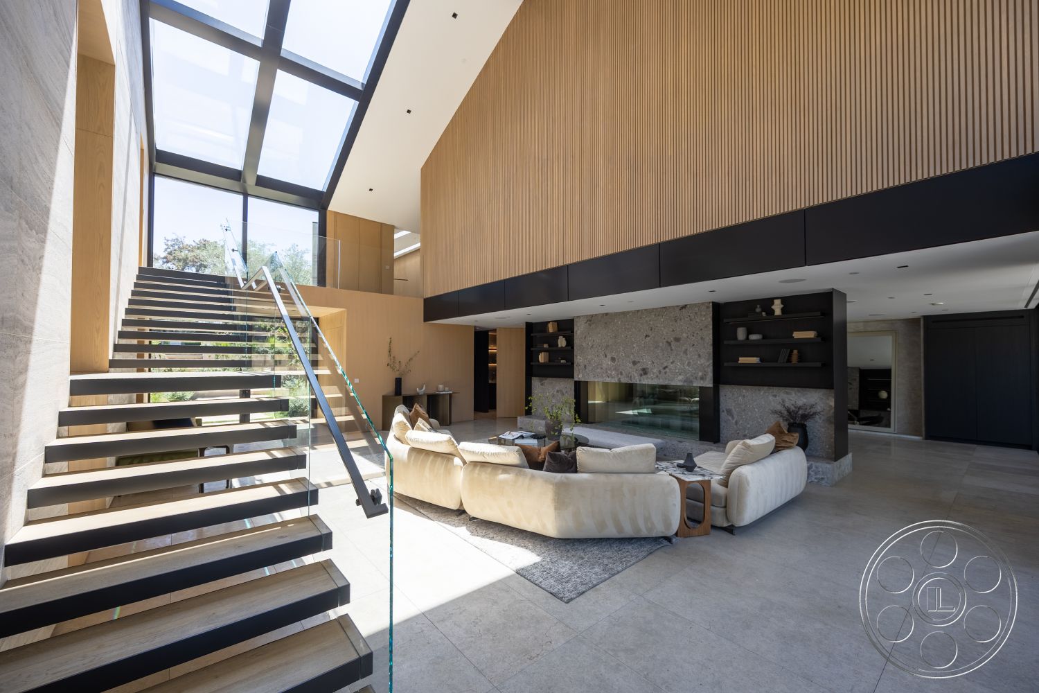 Modern 510 - neutral color palette, natural light, polished concrete flooring, cozy seating arrangement, dark cabinetry, interior space, floor-to-ceiling windows, airy atmosphere, sculptural staircase, innovative design elements, architectural detailing, glass stair railing, exposed wood ceiling beams, contemporary lounge area, wood slat wall treatment, integrated shelving units, textured stone fireplace wall, modern minimalist furniture, floating stairs, large open living area