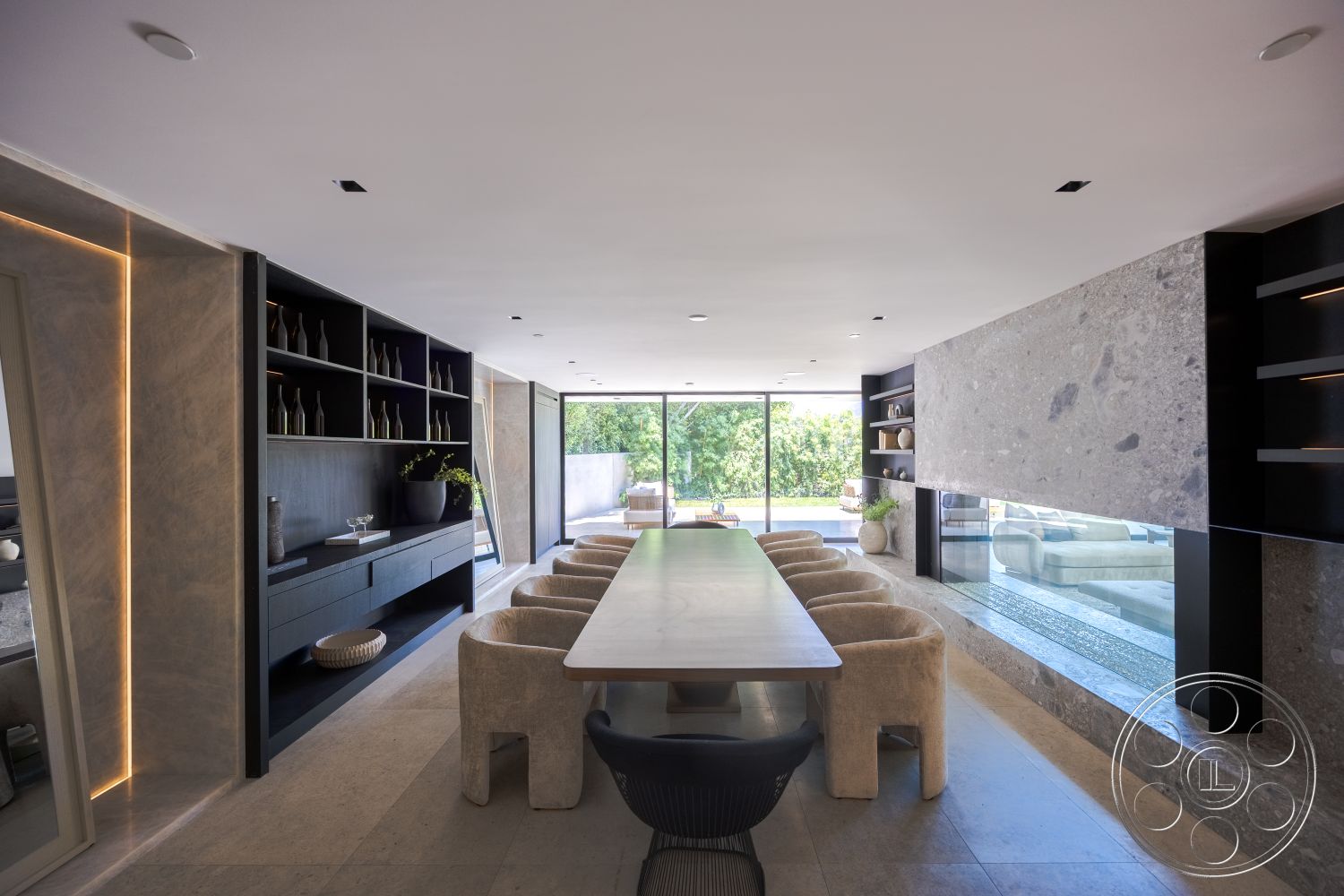 Modern 510 - conference room, neutral color palette, marble accent wall, large floor-to-ceiling windows, concrete wall panels, minimalist architectural style, natural wood dining table, interior dining area, glass partition wall, seamless indoor-outdoor connection, indoor plant integration, light-colored concrete flooring, black built-in shelving, rounded stone dining chairs, linear LED lighting design, well-lit open space, contemporary decor elements, modern design aesthetic, natural light optimization, elegant texture contrast