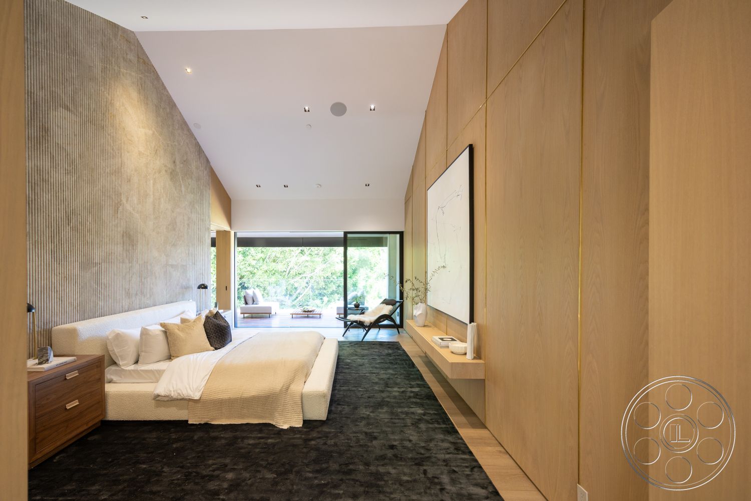 Modern 510 - neutral color palette, seamless indoor-outdoor transition, natural light from large windows, scenic garden view, modern minimalist design, built-in shelving unit, floor-to-ceiling glass doors, soft wool area rug, interior oak wood paneling, exposed textured plaster wall, luxury bedroom suite, contemporary art piece on wall, low-profile upholstered bed, flush-mounted ceiling lights, streamlined bedside table, wide plank hardwood flooring