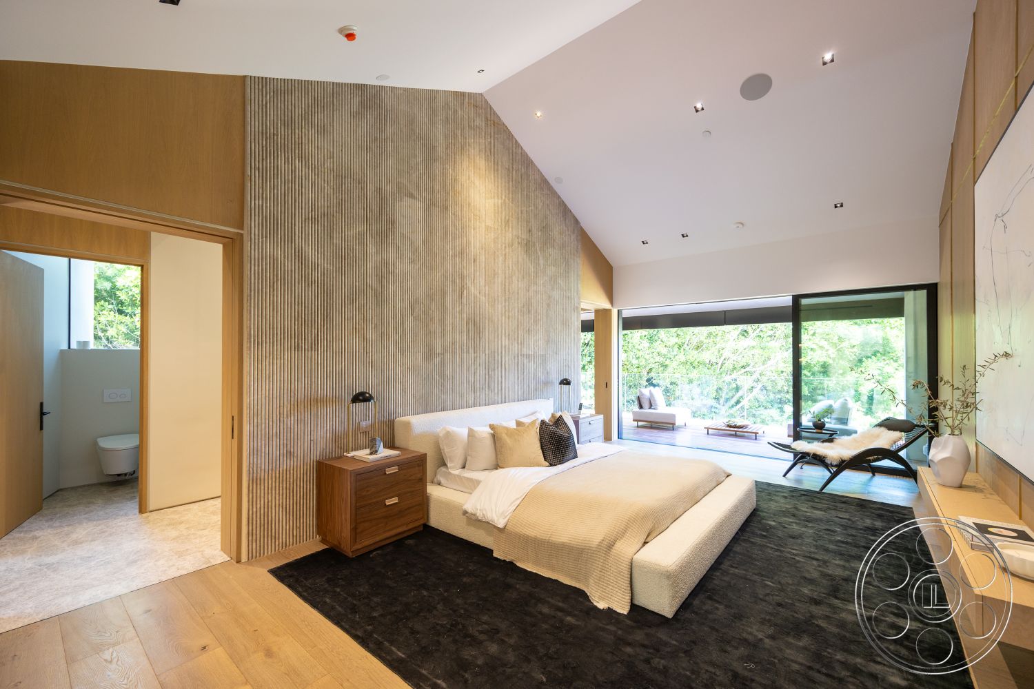 Modern 510 - neutral color palette, indoor-outdoor flow, floor-to-ceiling windows, patterned area rug, glass sliding doors, simple geometric shapes, minimalist interior design, hardwood bedroom floors, ensuite, textured wall treatments, lush garden view, natural light abundance, exposed concrete accent wall, functional room layout, sloped ceiling design, modern bedside table, contemporary bedroom layout, stylish lounge chair, wood accent panels, tranquil bedroom setting