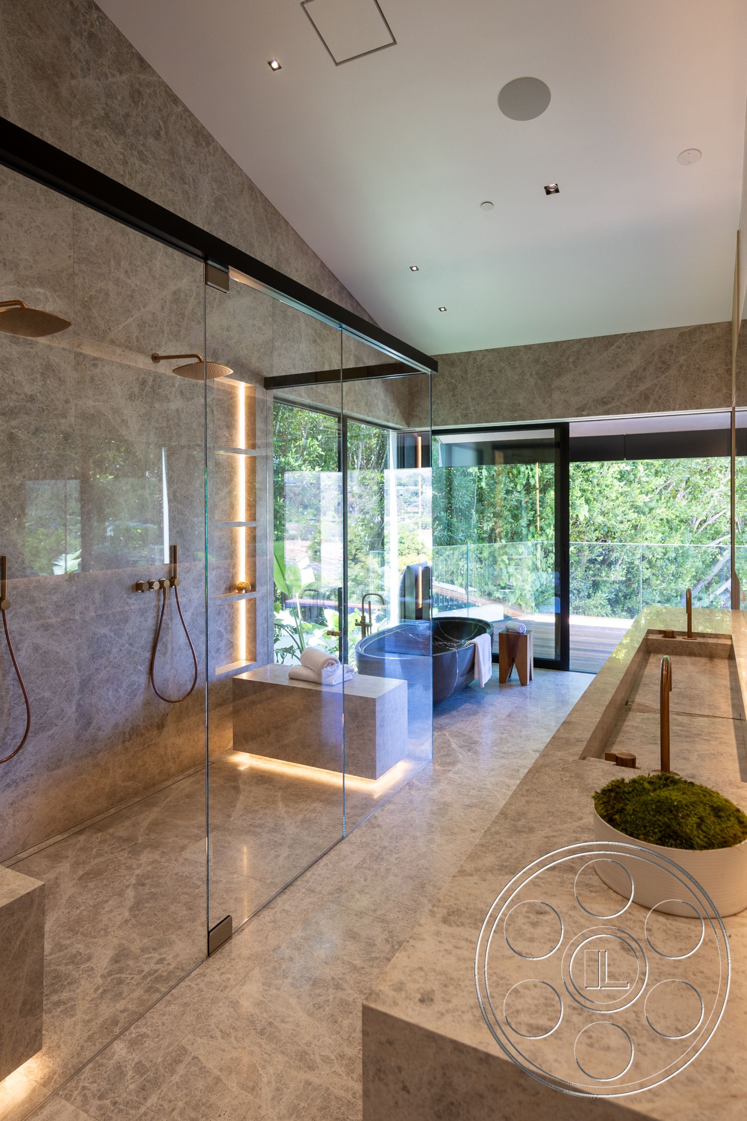 Modern 510 - bathroom, glass shower enclosure, seamless indoor-outdoor flow, floor-to-ceiling windows, marble flooring, minimalist design elements, modern architectural style, textured wall panels, suspended ceiling lights, exposed shower plumbing, modern freestanding bathtub, marble bathroom walls, natural light-filled interior, contemporary double vanity, brushed brass faucet fixtures, floating bathroom cabinets, indoor greenery accents, luxurious spa-like atmosphere, private outdoor view, exterior deck access