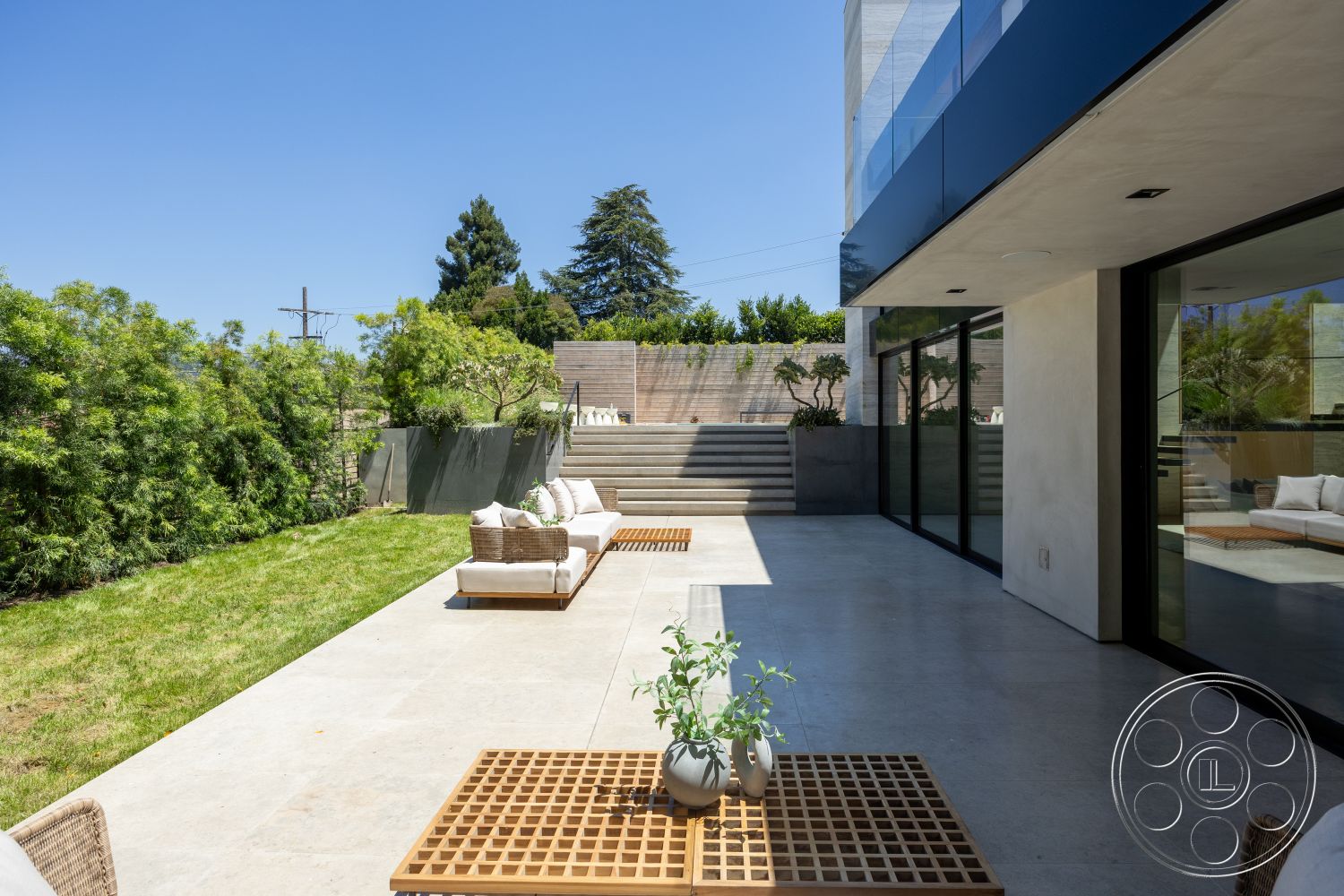 Modern 510 - sliding glass doors, landscaped garden area, minimalist architectural style, multilevel, exterior concrete patio flooring, modern concrete walls, wooden outdoor seating, grassy backyard setting, concrete steps leading to elevated area, lawn with shrubs and trees, geometric outdoor furniture design, horizontal wood fence, bright sunny outdoor environment