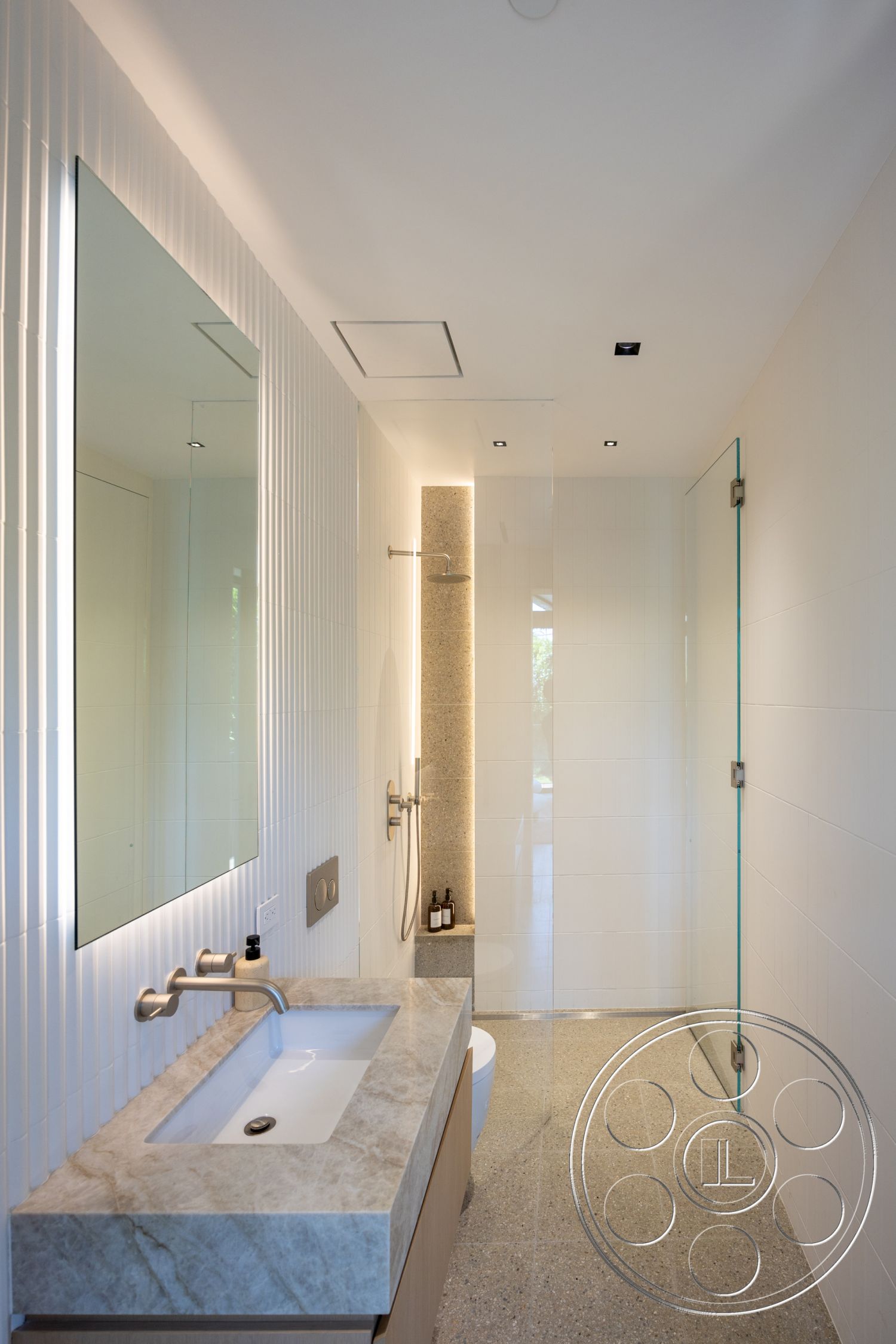 Modern 510 - textured plaster bathroom walls, glass shower doors, minimalist bathroom design, contemporary bathroom interior, polished concrete bathroom floors, natural stone shower wall, under-mounted sink with stone countertop, slim-line mirror with integrated lighting, ambient recessed lighting fixtures, modern faucet with brushed nickel finish, spa-like bathroom atmosphere, neutral color palette with subtle textures, geometric tile wall treatment, functional and aesthetic bathroom layout, luxurious materials in compact space, white