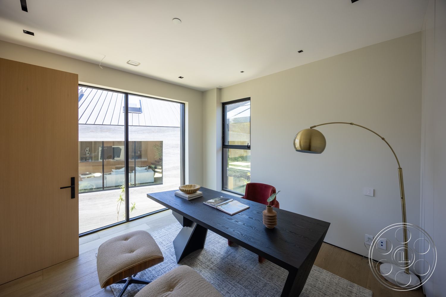 Modern 510 - neutral wall colors, textured wall panels, geometric area rug, large floor-to-ceiling windows, clean lines architecture, open layout design, decorative ceramic vase, natural wood door, interior office space, contemporary hardwood flooring, minimalist black wood desk, upholstered accent chair, gold arc floor lamp, modern office furnishings, stylish indoor plants, structured ceiling lights, urban courtyard view