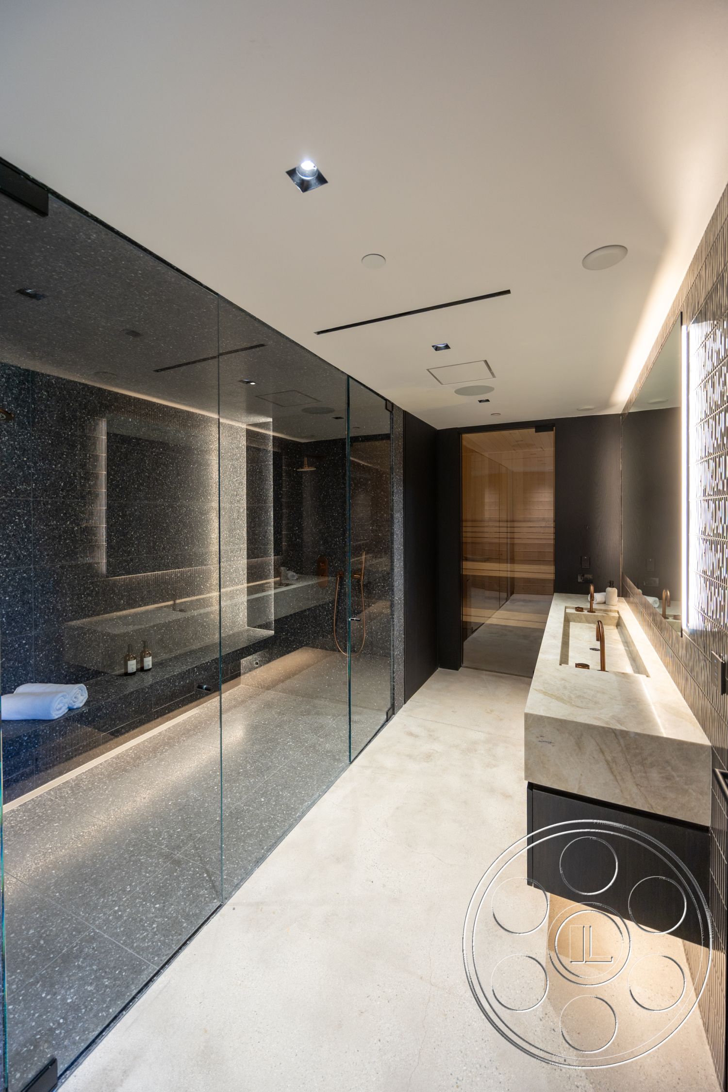 Modern 510 - neutral color palette, glass shower enclosure, floating vanity, exposed concrete wall, modern interior, black cabinetry, recessed lighting fixtures, minimalist bathroom, terrazzo bathroom flooring, marble countertop vanity, open shower design, interior spa area, textured tile wall, luxury bath setting, contemporary glass partition