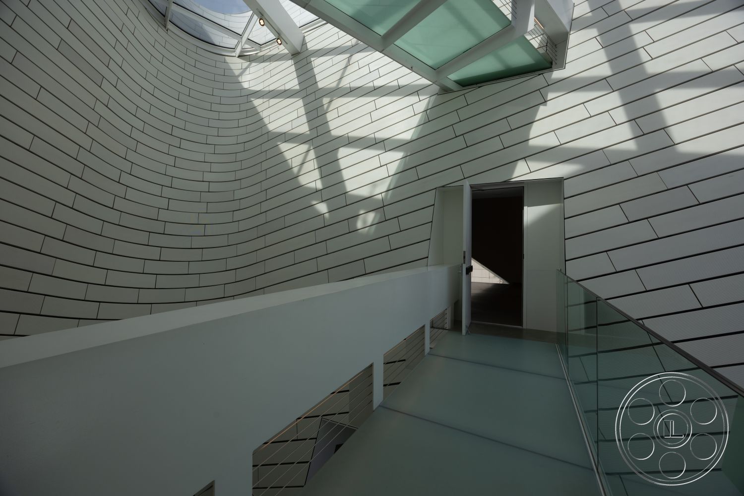 Museum 4 - interior minimalist design elements, interior polished concrete floor, interior glass ceiling, interior curved white tile walls, interior floating glass staircase, interior shadow play from skylight, interior sleek handrail details, interior geometric architectural forms, interior modern door design