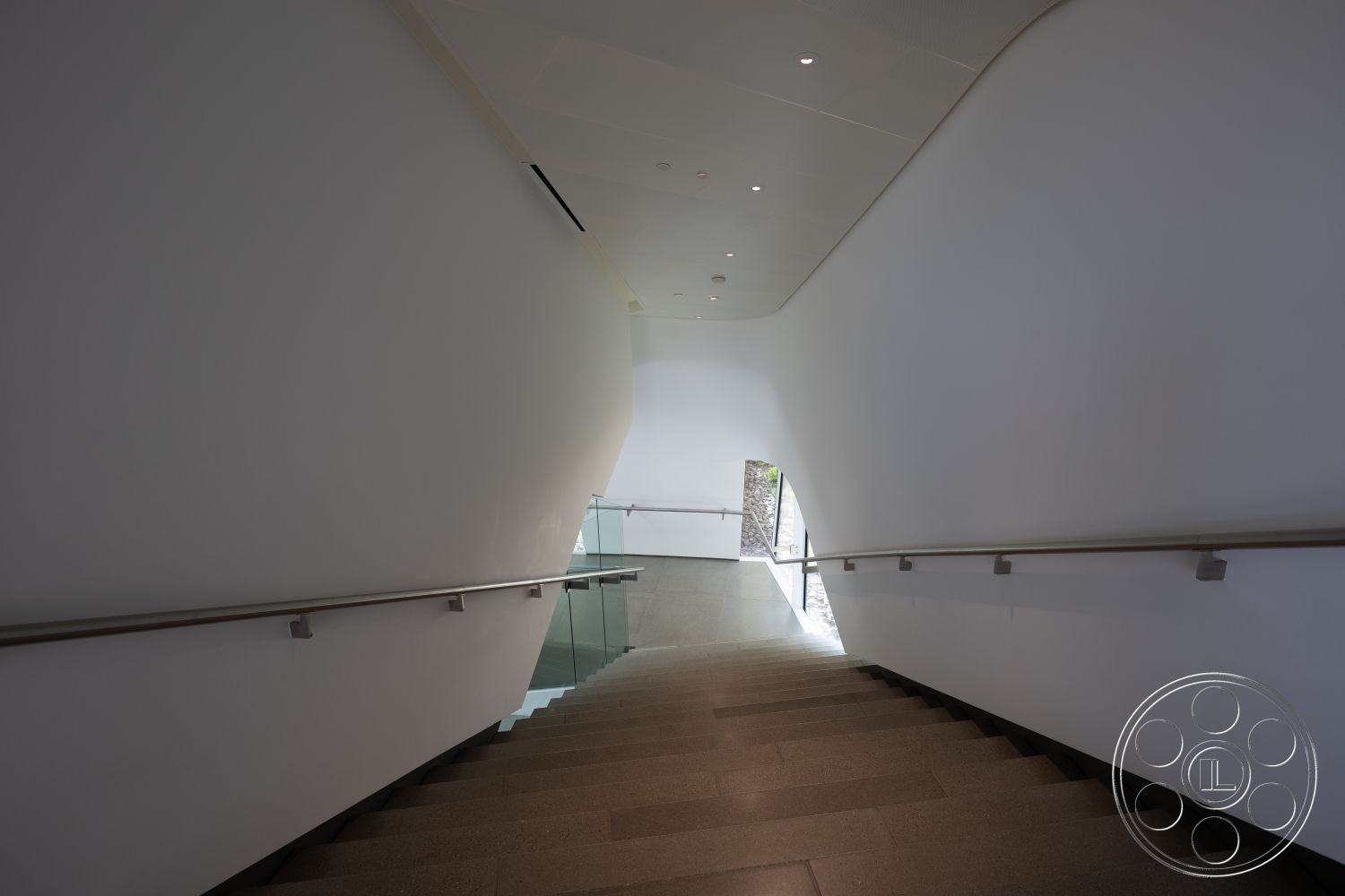 Museum 4 - glass railing, minimalist architectural design, large glass window, interior curved staircase, polished concrete steps, white smooth walls, modern ceiling lights, open space foyer, natural light streaming, streamlined contemporary aesthetics