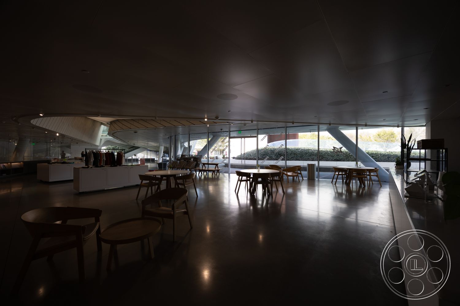Museum 4 - neutral color palette, contemporary furniture, open floor plan, polished concrete flooring, urban setting, white painted walls, natural light exposure, floor-to-ceiling glass walls, minimalist interior, curved ceiling design, modern commercial space, exposed structural beams, interior commercial space, wooden dining tables, integrated greenery design