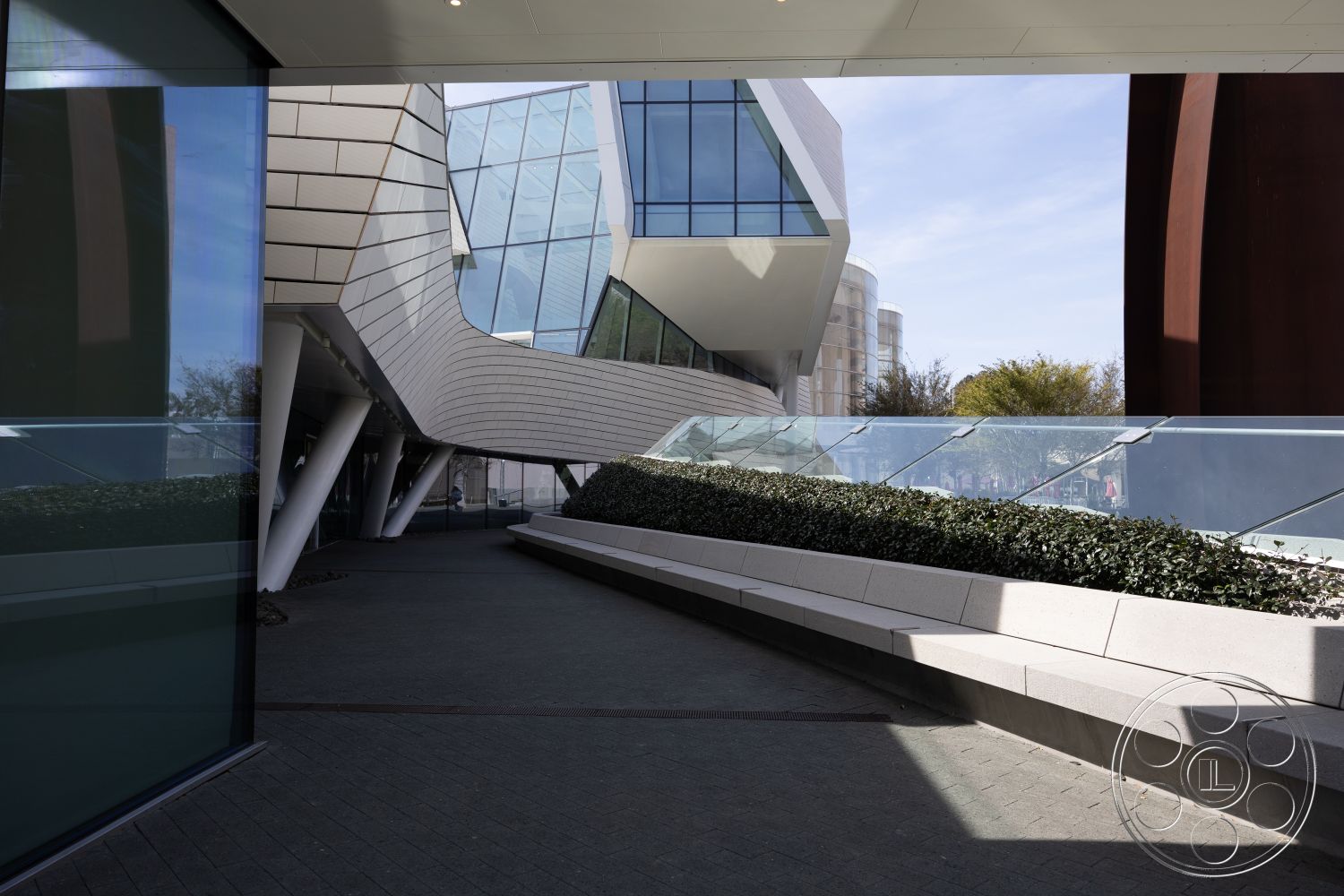 Museum 4 - interior open-concept layout, interior large glass windows, interior polished concrete flooring, modern architectural details, exposed structural steel columns, urban plaza setting, exterior outdoor seating area, exterior concrete walkways, exterior glass curtain walls, exterior metal panel cladding, exterior angled roof lines, exterior landscaped planter beds, exterior stainless steel railing, exterior geometric building forms, textured stone base wall, exterior smooth white stucco finish, exterior green facade landscaping, exterior cantilevered structures, interior dynamic space configuration, curved exterior lines, modern art installation environment