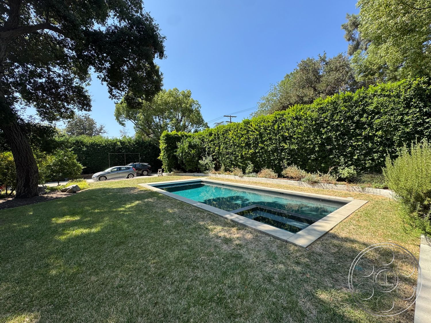 Craftsman 20 - concrete pool deck, rectangular pool, exterior garden, concrete pool border, urban residence setting, sunny outdoor environment, natural grass landscaping, surrounding hedge wall, patio grass area, modern backyard design