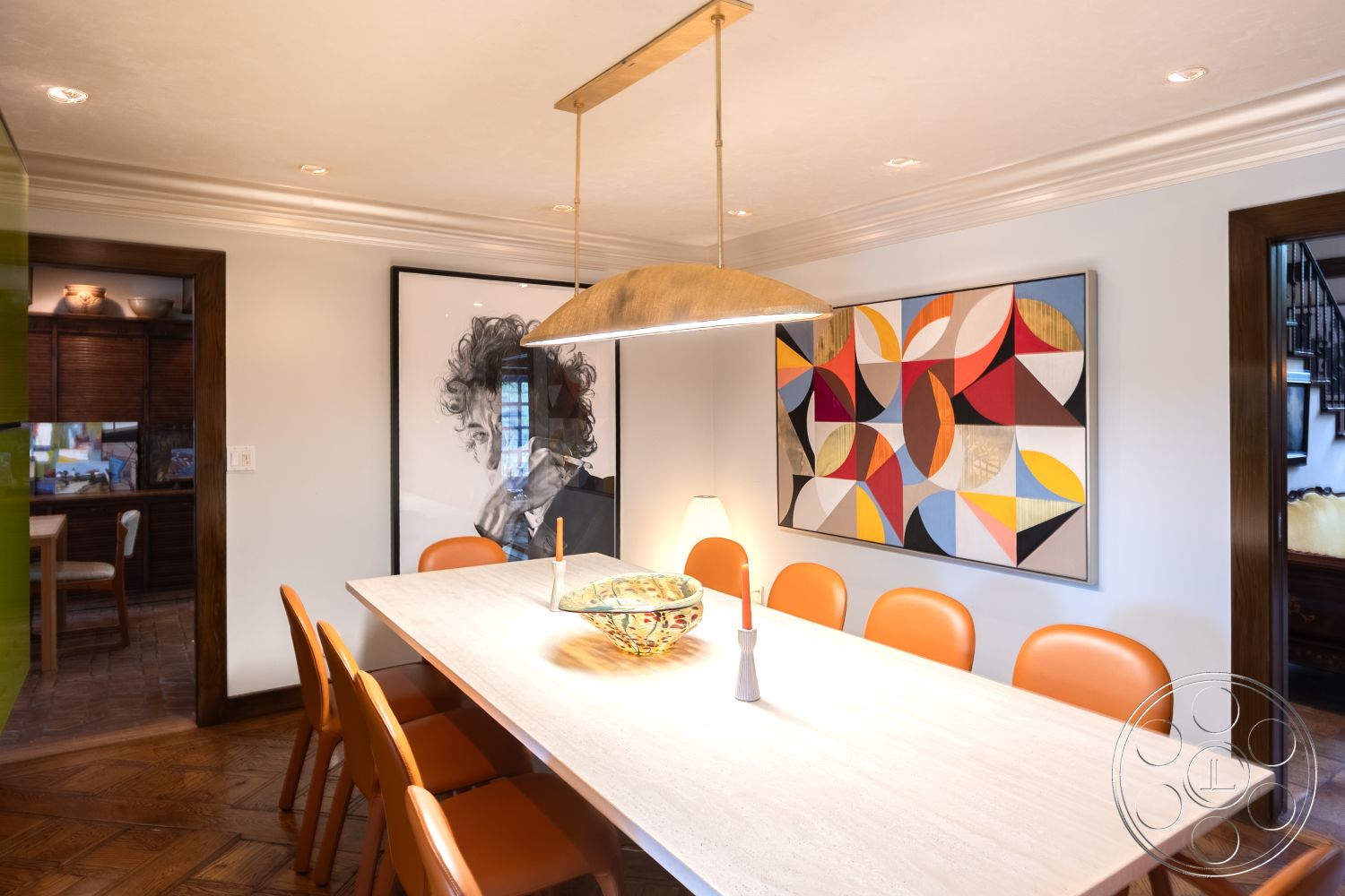 Mansion 2 - minimalist decor, natural light, open floor plan, modern pendant lighting, soft ambient lighting, rectangular dining table, built-in cabinetry, interior dining room, white painted walls, crown molding details, walnut wood paneling, herringbone patterned hardwood flooring, geometric abstract wall art, orange upholstered dining chairs, interior with modern aesthetics