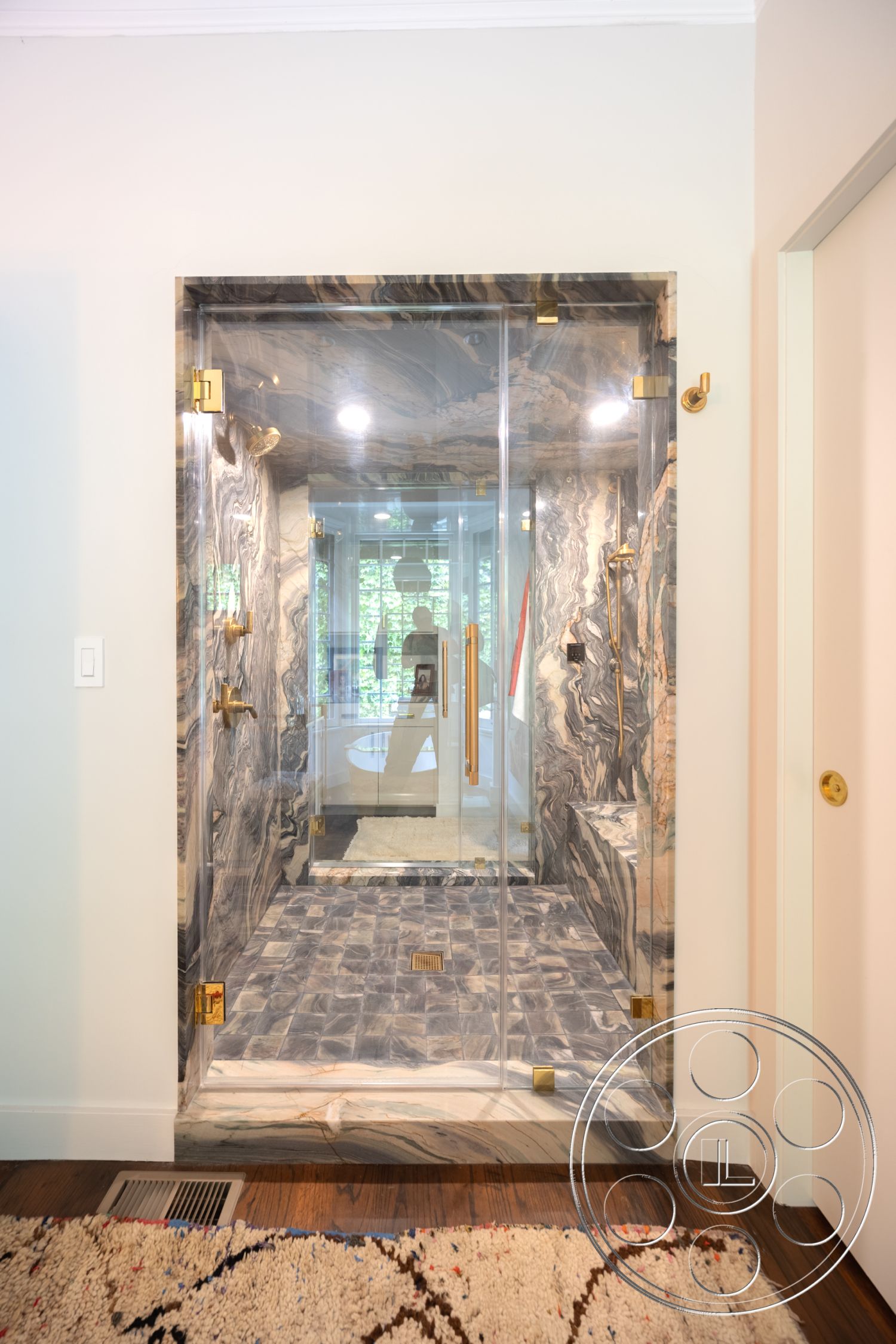 Mansion 2 - neutral color palette, dark hardwood floor, floor-to-ceiling glass, marble flooring, brushed brass accents, hexagonal tile flooring, glass shower doors, exposed plumbing details, modern minimalist style, modern bathroom design, marble shower walls, gold hardware fixtures, textured natural stone, open shower layout, interior luxury bathroom, tray ceiling, contemporary spa-like retreat, seamless glass enclosure, high-end bathroom finishes