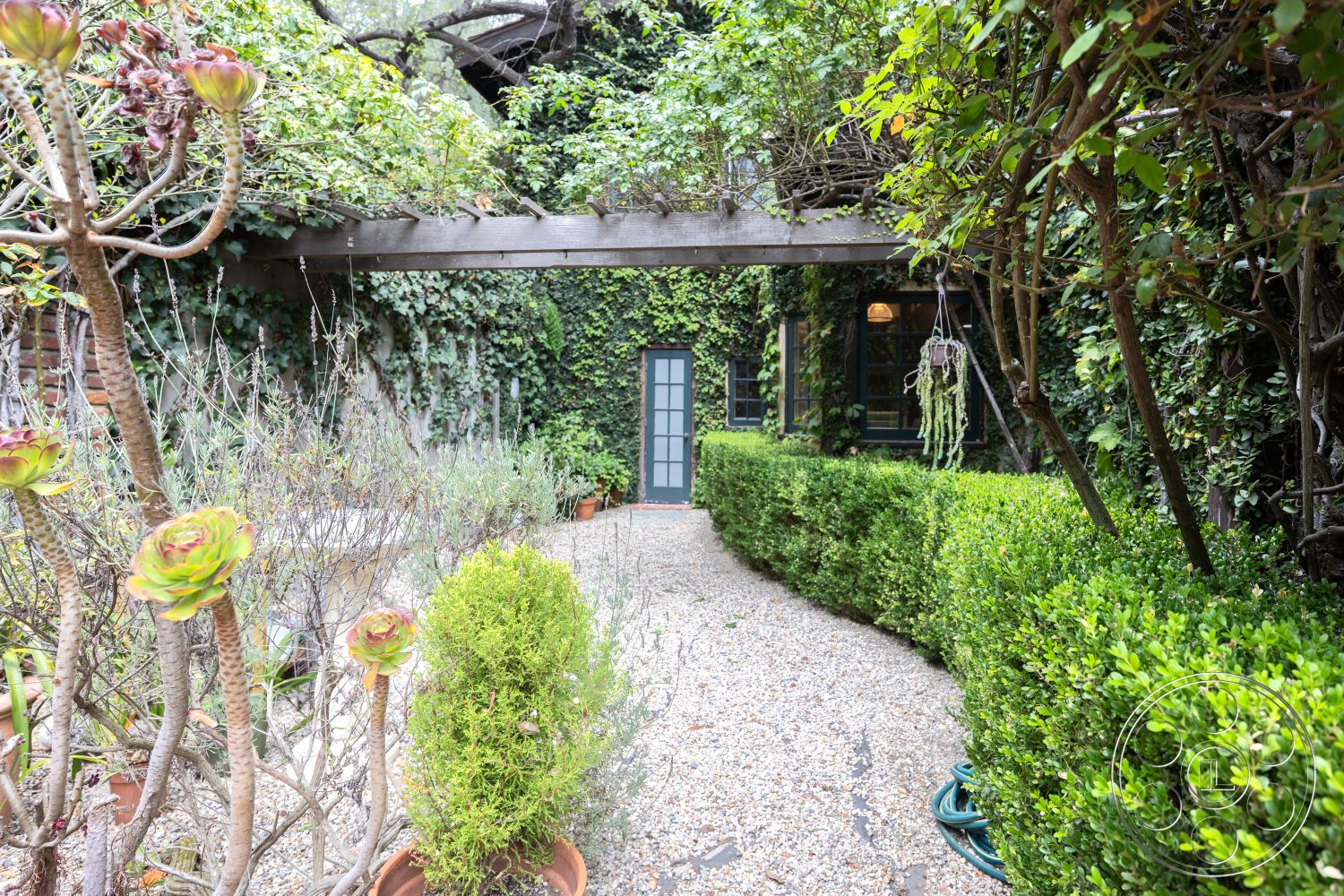 Mansion 2 - lush greenery, natural landscaping, patio area, hanging planters, gravel pathway, eco-friendly design, urban garden, boxwood hedges, wood pergola, green ivy wall, outdoor garden setting, exterior garden space, framed garden door, succulent garden plants, tranquil outdoor retreat