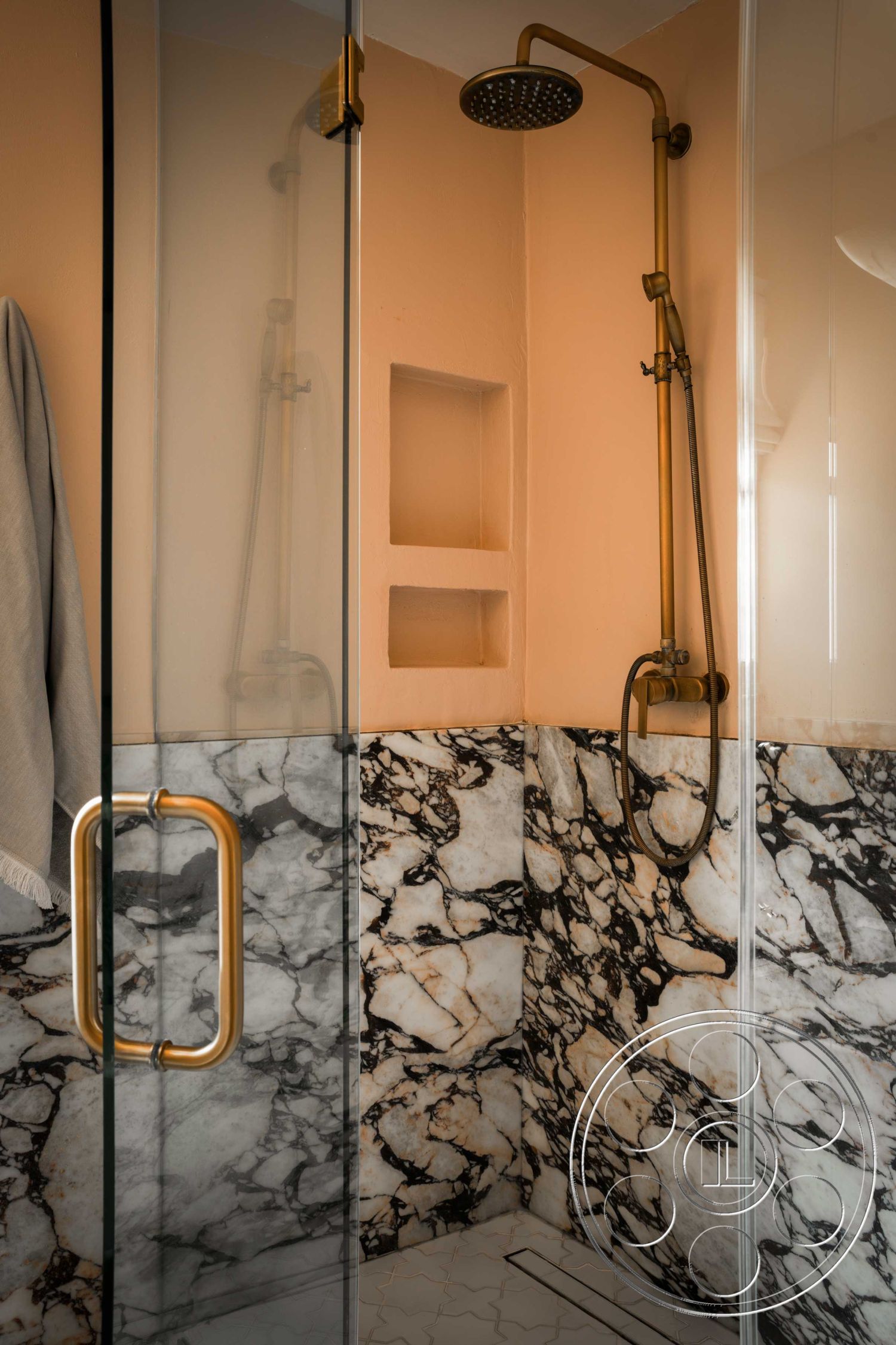 Spanish 166 - textured plaster walls, glass shower doors, marble shower walls, hexagonal tile flooring, ensuite, gold faucet fixtures, contemporary bathroom design, black and white veined marble, gold finish showerhead, recessed shower niche, luxury bathroom interior