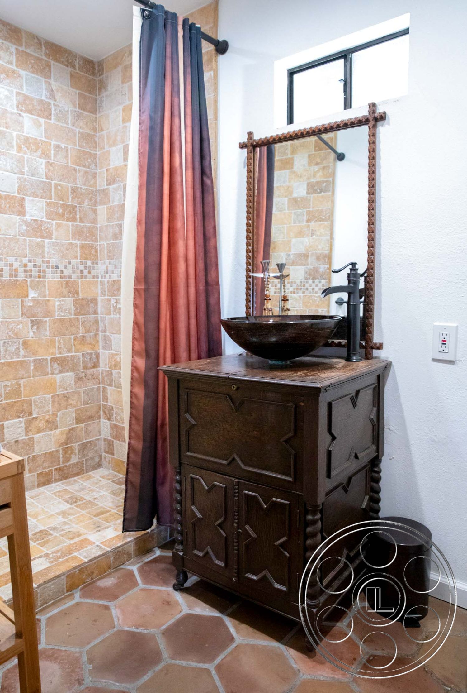 Medit 31 - textured plaster walls, modern farmhouse aesthetic, wooden vanity cabinet, natural stone shower walls, honeycomb tile flooring, metal vessel sink, bronze faucet fixture, shower curtain with gradient colors, rectangular mirror with decorative frame, large window with black metal frame, rustic accent elements, compact bathroom design, warm-toned color palette, cozy bathing area, earthy material combination