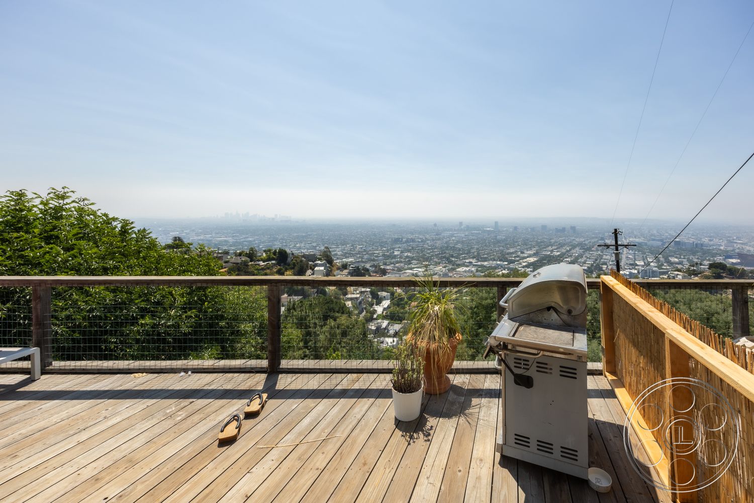 Retro 294 - grill area, outdoor living space, natural wood finishes, horizontal wood fencing, contemporary design elements, city skyline view, landscape greenery, casual outdoor seating, wooden lounge chairs, sunny outdoor space, mountain view setting, urban hillside location, wood deck flooring, open-air entertainment area, built-in planters, exterior deck railing, modern outdoor patio, sandy outdoor sandals
