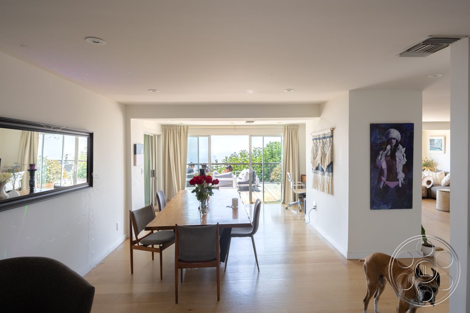 Retro 294 - neutral color palette, floor-to-ceiling windows, open concept living space, interior dining area, white painted walls, contemporary dining chairs, exposed ceiling with recessed lighting, light hardwood dining room floor, sliding glass doors to outdoor deck, modern minimalist dining table, decorative wall hangings, mirrored wall accent, vegetation view from interior