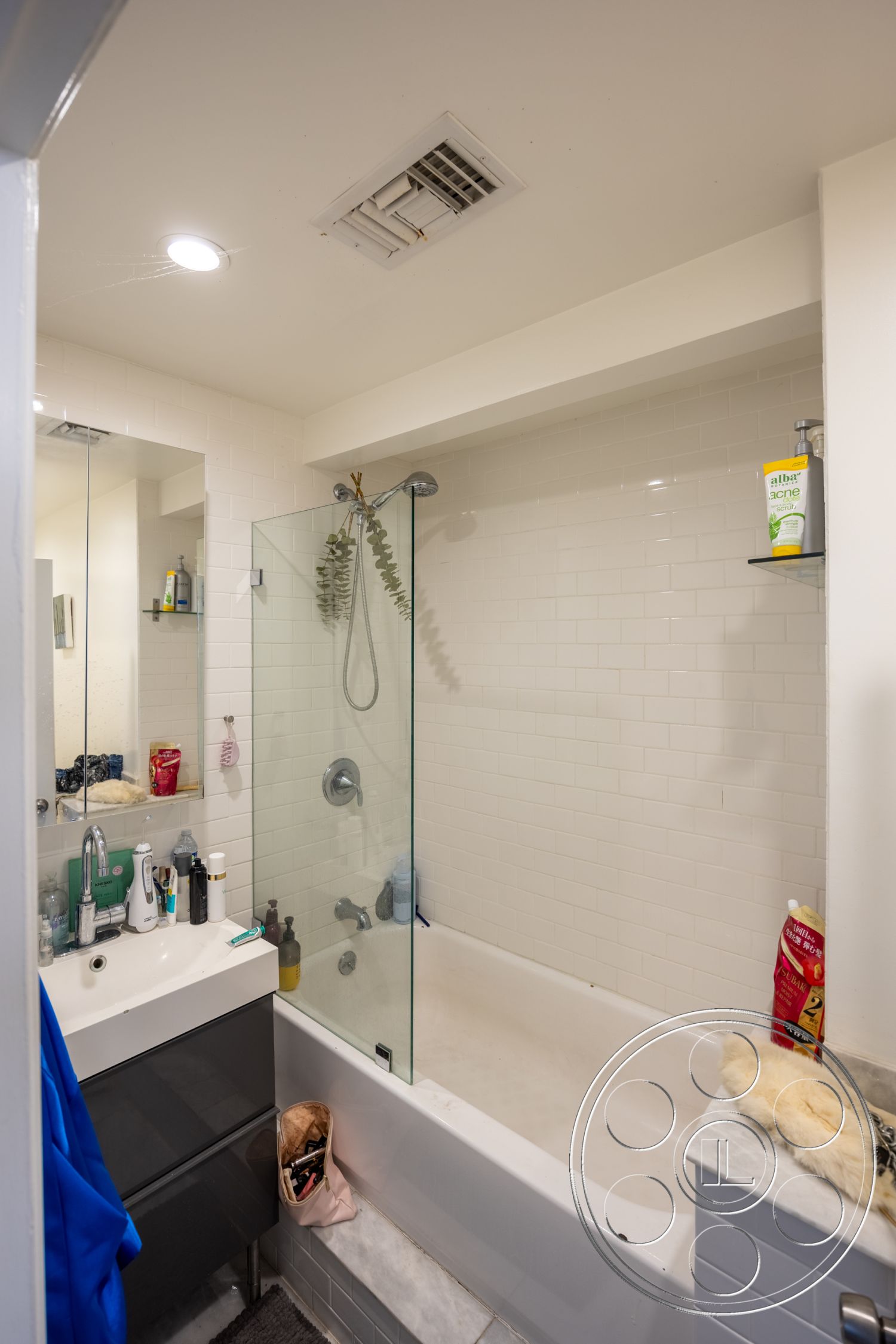 Retro 294 - textured wall finish, recessed ceiling lights, glass shower doors, minimalist bathroom design, interior bathroom space, chrome faucet fixtures, marble bathroom flooring, white subway tile shower walls, rectangular bathtub, modern bathroom cabinetry, sliding glass shower enclosure, built-in shower shelving