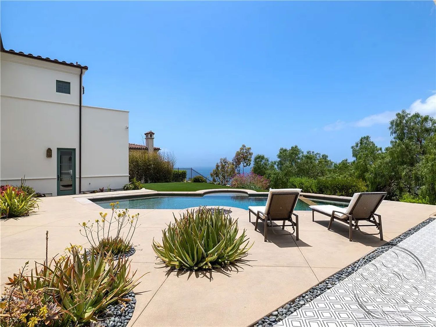 Spanish 167 - exterior concrete patio floor, exterior low-maintenance landscaping, exterior ocean view setting, exterior infinity pool, exterior contemporary architecture, exterior paved pool deck, exterior landscaped garden with succulents, exterior modern home with white stucco walls, modular patterned tile patio border, exterior outdoor lounge area with chaise lounges, exterior outdoor entertainment space