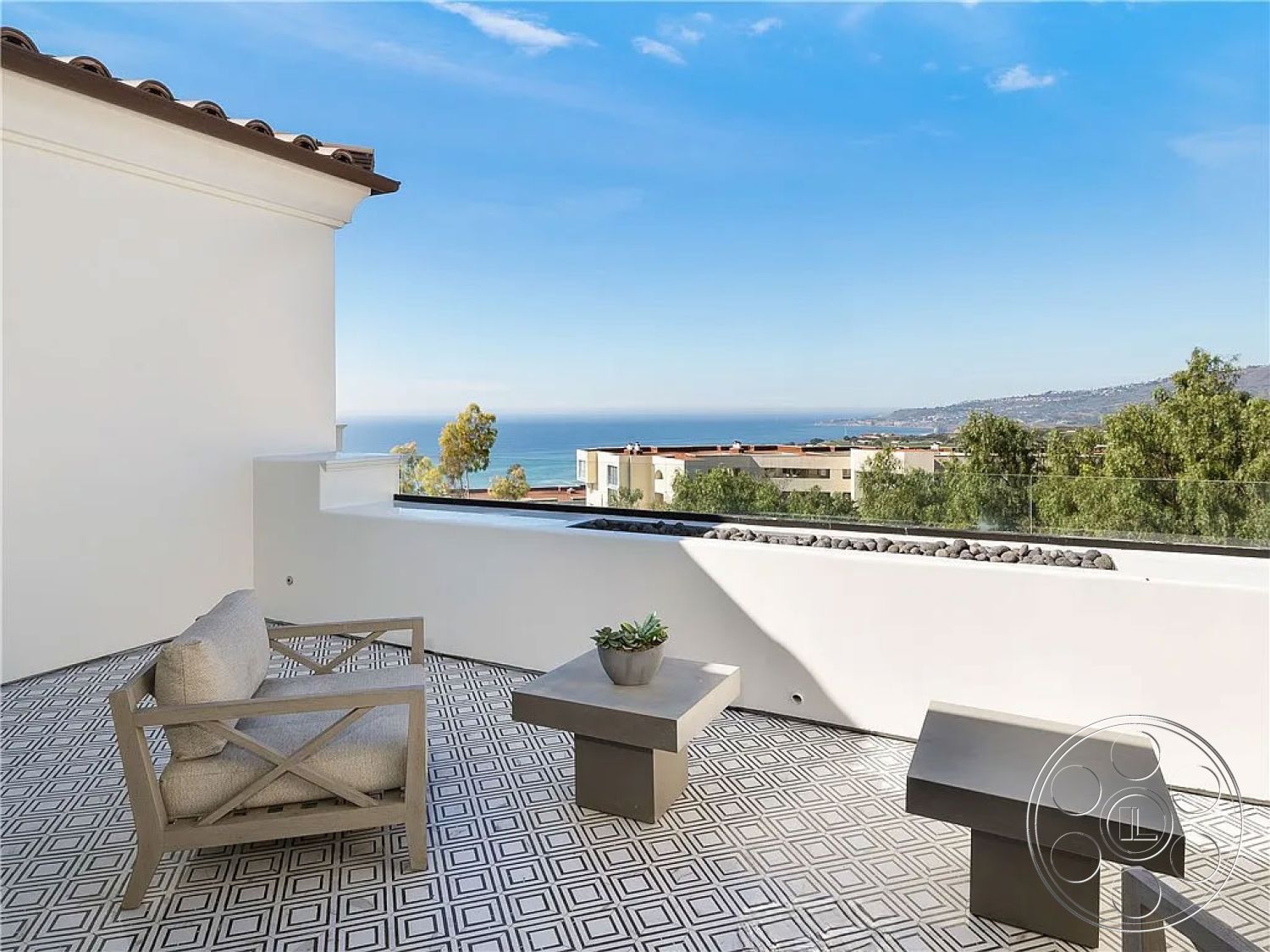 Spanish 167 - white stucco walls, glass railing, open outdoor space, contemporary outdoor seating, minimalist outdoor furniture, modern exterior design, outdoor patio flooring, geometric tile patio floor, ocean view balcony, urban hillside terrace, textured tile patterns