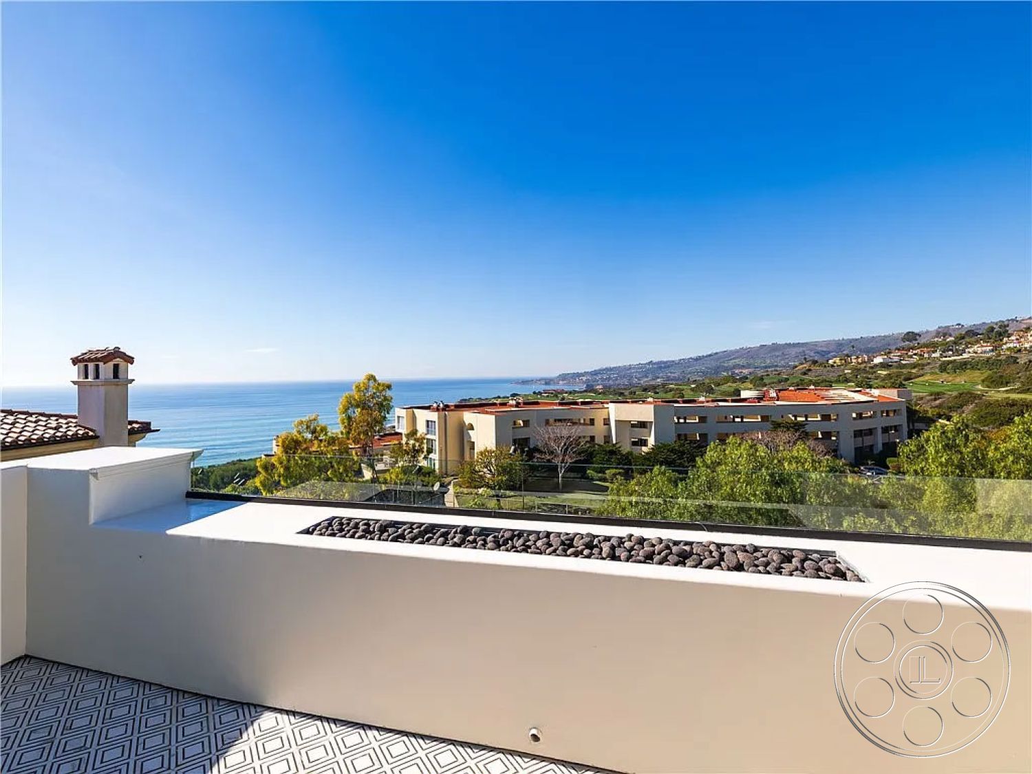 Spanish 167 - Mediterranean architectural style, landscaped garden area, glass railing balcony, aluminum outdoor furniture, urban hillside view, exterior oceanfront balcony, stone firepit with lava rocks, decorative tile patio flooring, contemporary stucco walls, terraced hillside property