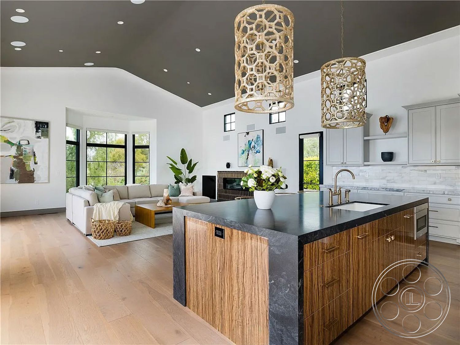 Spanish 167 - neutral color palette, textured wall art, light wood cabinetry, comfortable sectional sofa, large floor-to-ceiling windows, stylish coffee table, inviting gathering space, minimalist aesthetics, contemporary interior design, exposed wood ceiling beams, hardwood living room floors, marble kitchen backsplash, decorative indoor plants, vaulted living room ceiling, natural light-filled spaces, black stone kitchen island countertop, decorative hanging light fixtures, modern open floor plan, urban setting with greenery