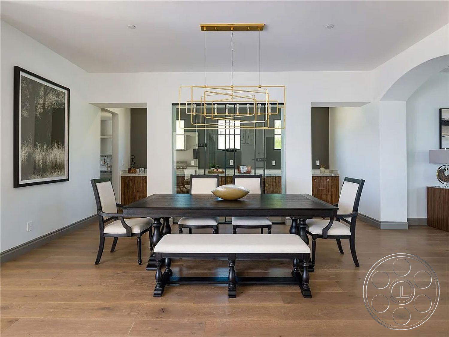 Spanish 167 - neutral color palette, floor-to-ceiling windows, geometric pendant lighting, rectangular dining table, sophisticated aesthetic, arched entryways, minimalist design details, open layout interior, hardwood dining room floors, natural light filled space, built-in kitchen cabinetry, black wooden dining chairs, beige upholstered bench, textured white walls, glass panel room divider, contemporary dining room, modern style decor, simple elegance in design, functional dining area