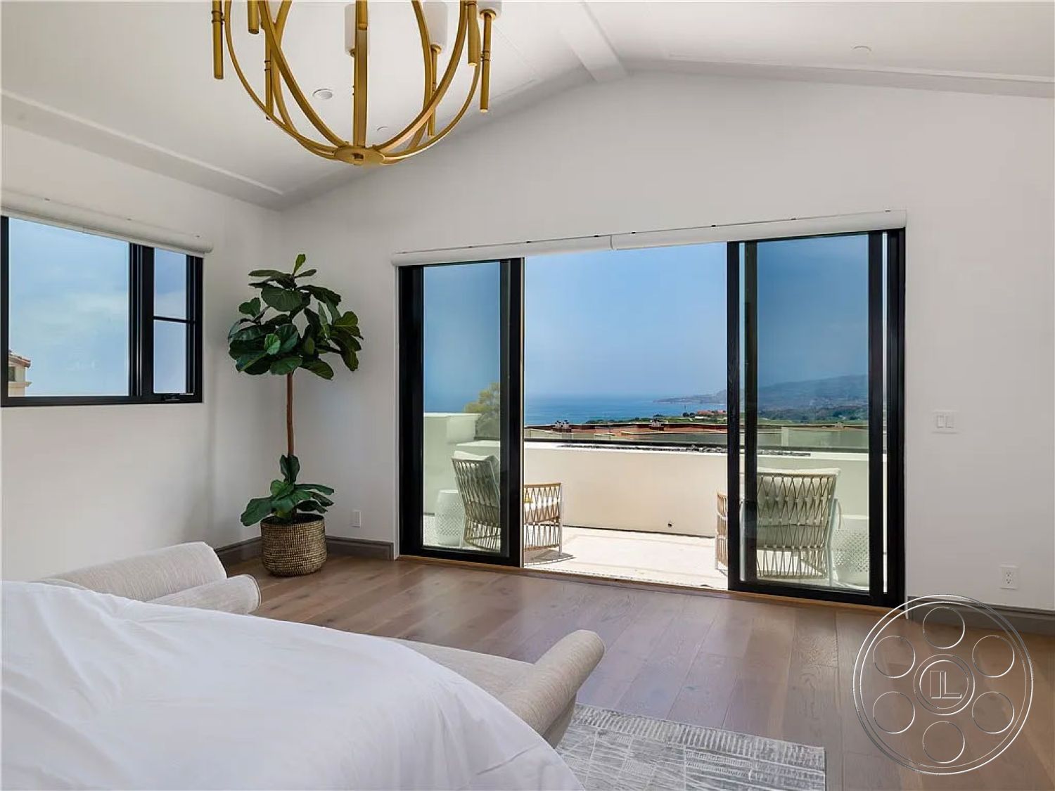 Spanish 167 - light-colored walls, textured area rug, glass sliding doors, open concept design, suburban setting, outdoor terrace, coastal view, hardwood bedroom floors, luxury master bedroom, modern chandelier lighting, minimalist interior, horizontal window design, floating ceiling beams, potted indoor plant, panoramic seaview, white accent walls