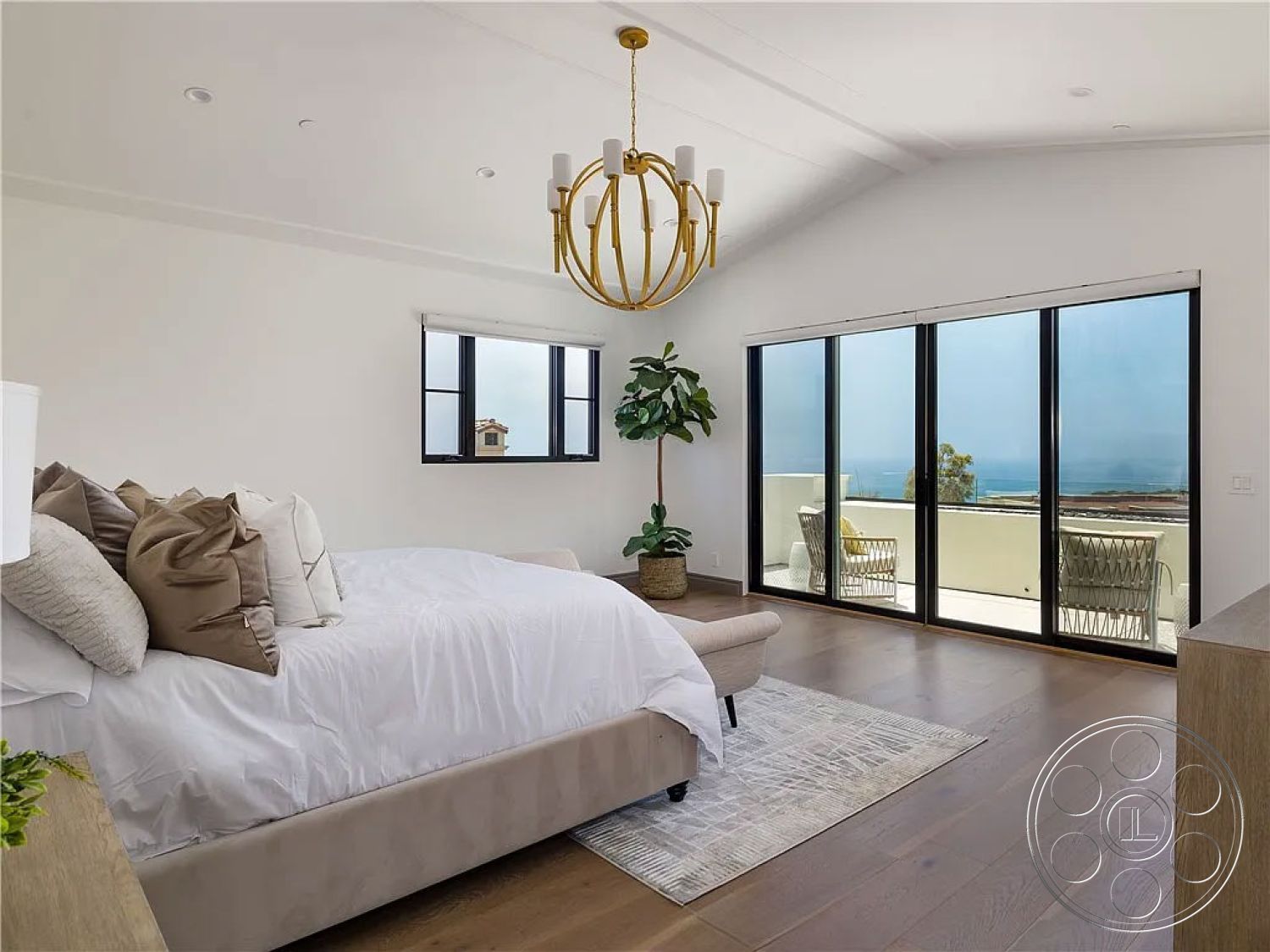 Spanish 167 - textured area rug, floor-to-ceiling windows, vaulted ceiling, modern chandelier, interior bedroom, hardwood bedroom floors, contemporary bedroom design, white painted walls, indoor potted plant, beachfront property setting, plush bedding with decorative pillows, open balcony view