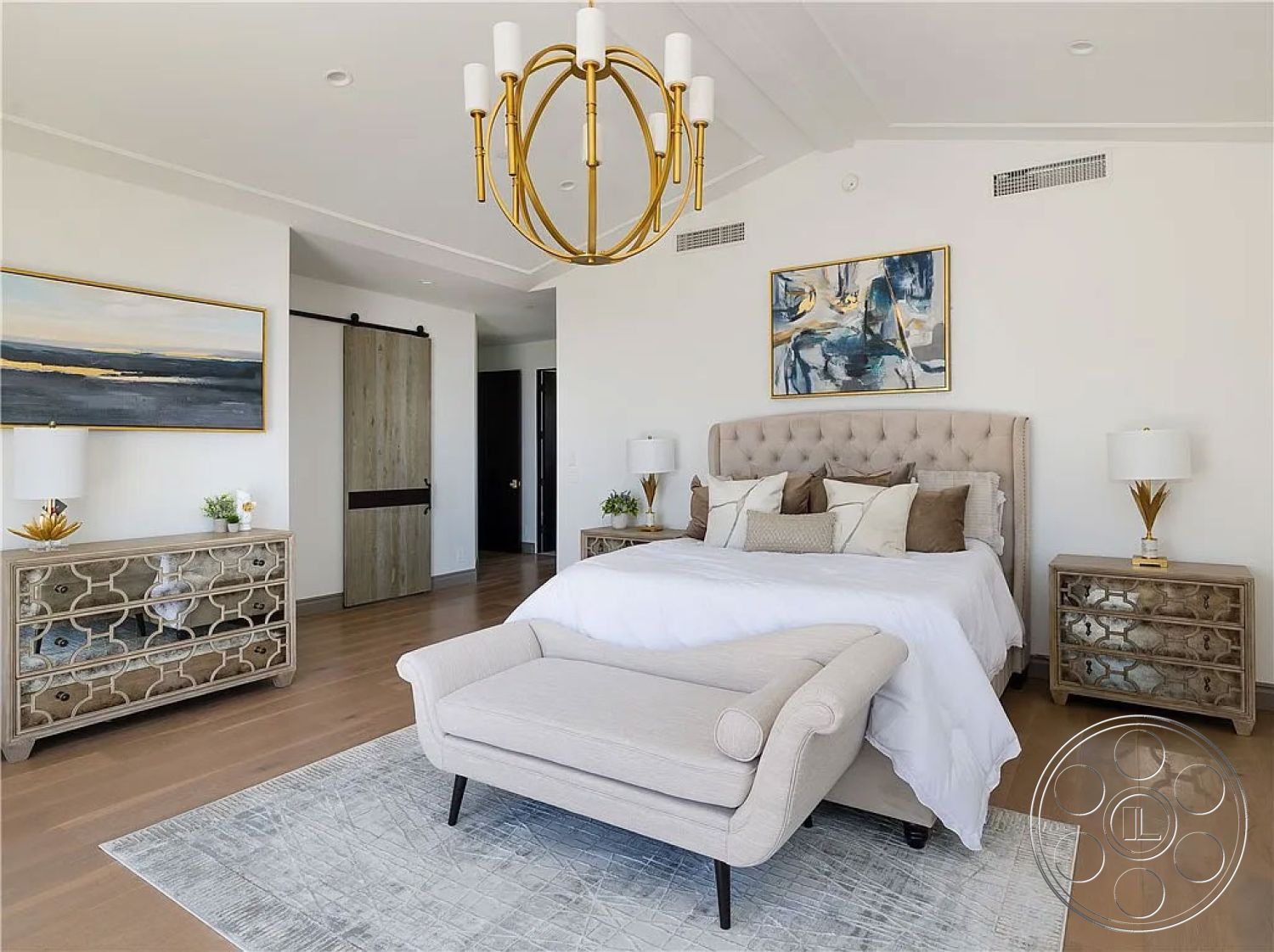 Spanish 167 - neutral color palette, spacious layout, soft area rug, textured plaster walls, decorative throw pillows, glass side tables, cozy reading nook, exposed ceiling beams, luxurious bedding, modern bedside lamps, sliding barn door, hardwood bedroom floors, tufted beige upholstered bed, gold pendant chandelier, abstract art wall decor