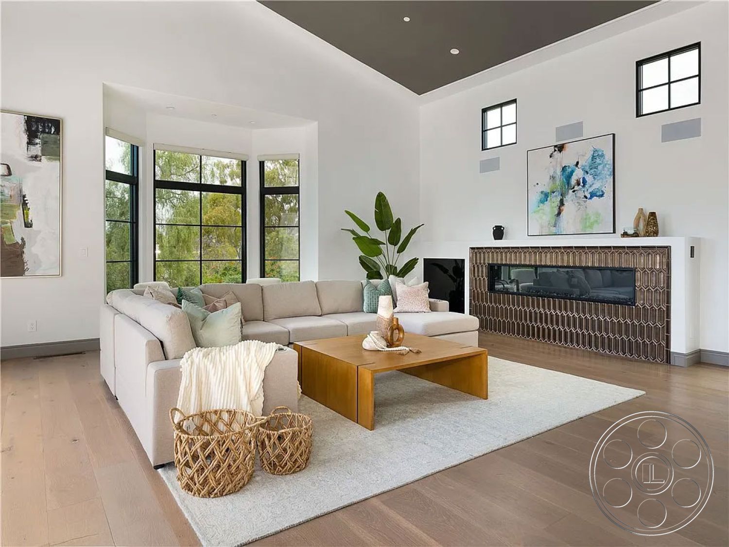 Spanish 167 - interior hardwood living room floors, interior exposed wood ceiling beams, interior white painted walls, interior abstract wall art, interior glass partition walls, interior vaulted living room ceiling, interior large bay windows, interior contemporary fireplace surround, interior geometric tile fireplace detail, interior modern coffee table, interior decorative woven baskets