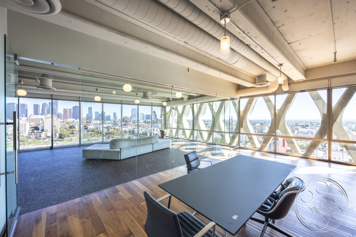Loft 158 - urban skyline view, exposed concrete ceiling, contemporary office space, glass partition walls, minimalist furniture design, floor-to-ceiling glass windows, open-concept interior, industrial-style lighting fixtures, wood plank flooring, spacious interior layout, modern conference room, textured concrete wall accents, wooden trim details, high ceilings with exposed ductwork, city balcony setting