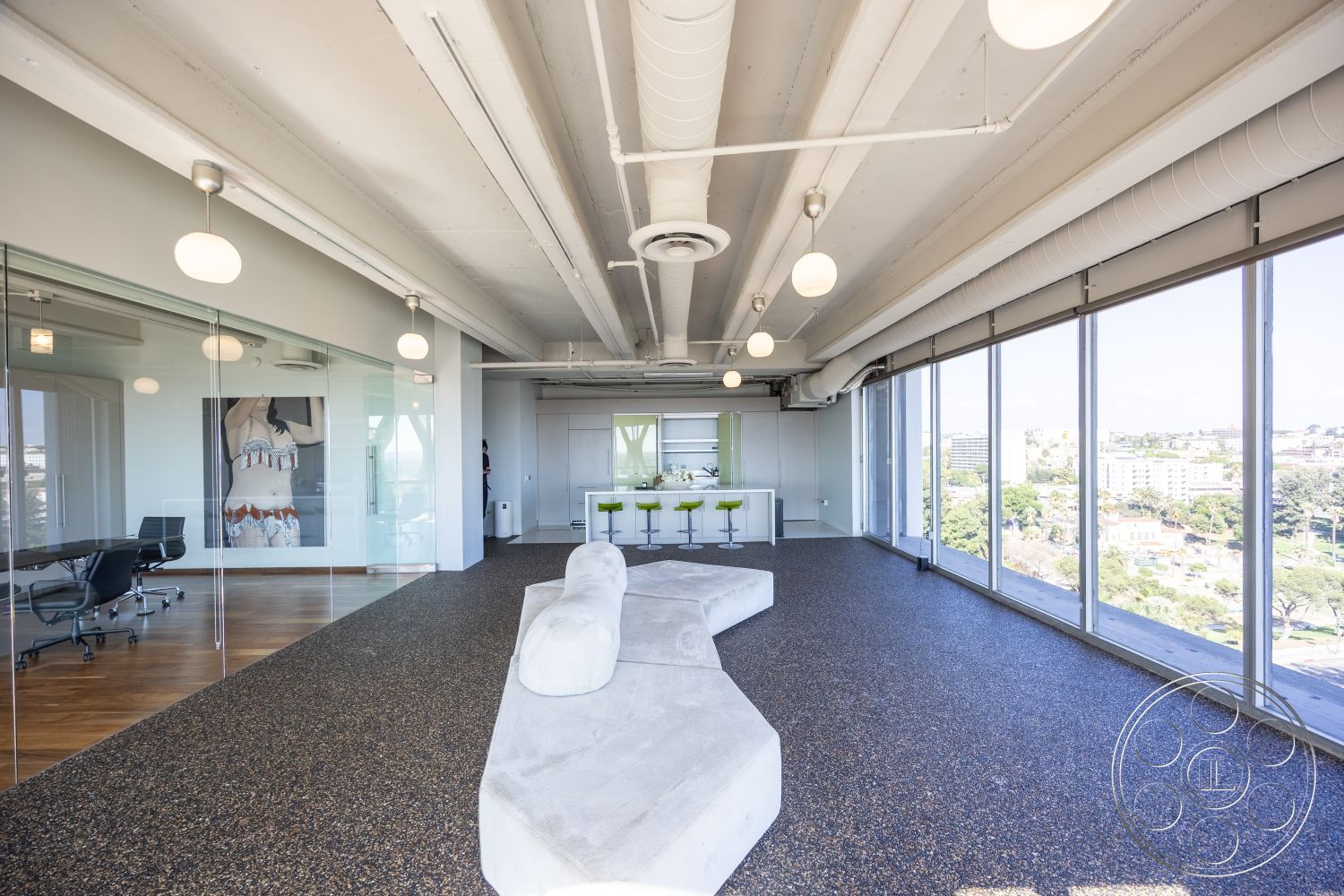 Loft 158 - minimalist design elements, industrial lighting fixtures, large floor-to-ceiling windows, exposed concrete ceiling, view of city skyline, glass partition walls, neutral painted walls, modern commercial interior, hardwood office flooring, terrazzo floor finish, open concept workspace layout, modern bar seating, contemporary art wall feature, curved lounge seating, brightly colored accent chairs, eco-friendly workspace design