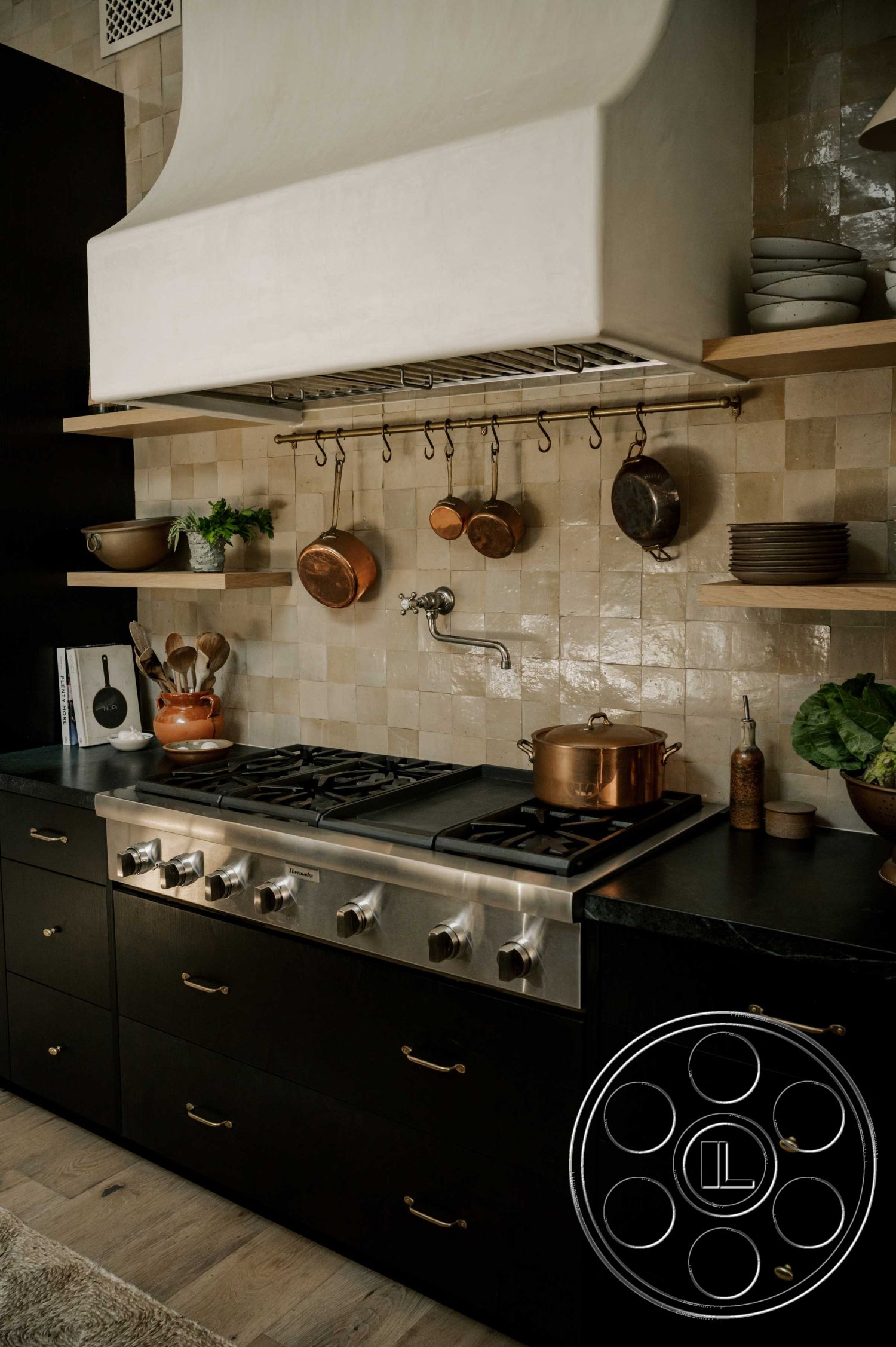 Americana 429 - black stainless steel appliances, textured tile backsplash, interior kitchen design, minimalist kitchen decor, functional kitchen workspace, modern range hood, open shelving kitchen, kitchen island with seating, black cabinetry kitchen, copper cookware display, quartz countertop kitchen, brushed brass cabinet hardware, natural wood open shelves, wood plank flooring kitchen, contemporary kitchen lighting, elegant pot filler faucet, pantry door kitchen, neutral color palette kitchen