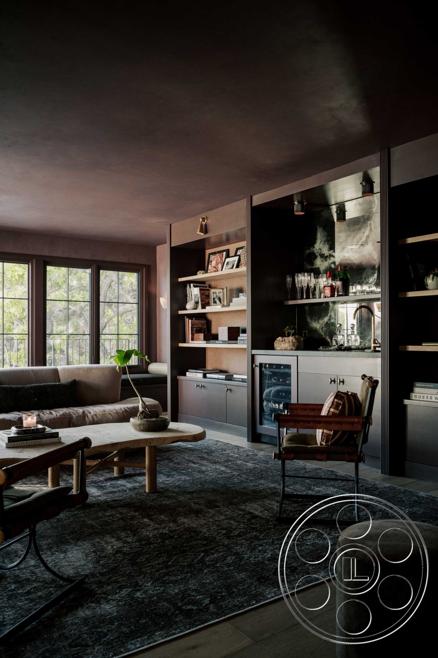 Americana 429 - hardwood flooring interior, neutral color palette interior, exposed wood ceiling beams interior, textured plaster walls interior, open concept living space interior, dark wood cabinetry interior, custom built-in shelves interior, marble bar countertop interior, large black framed windows interior, round wooden coffee table interior, velvet upholstered chair interior, area rug with intricate pattern interior, contemporary style interior, modern art decor interior