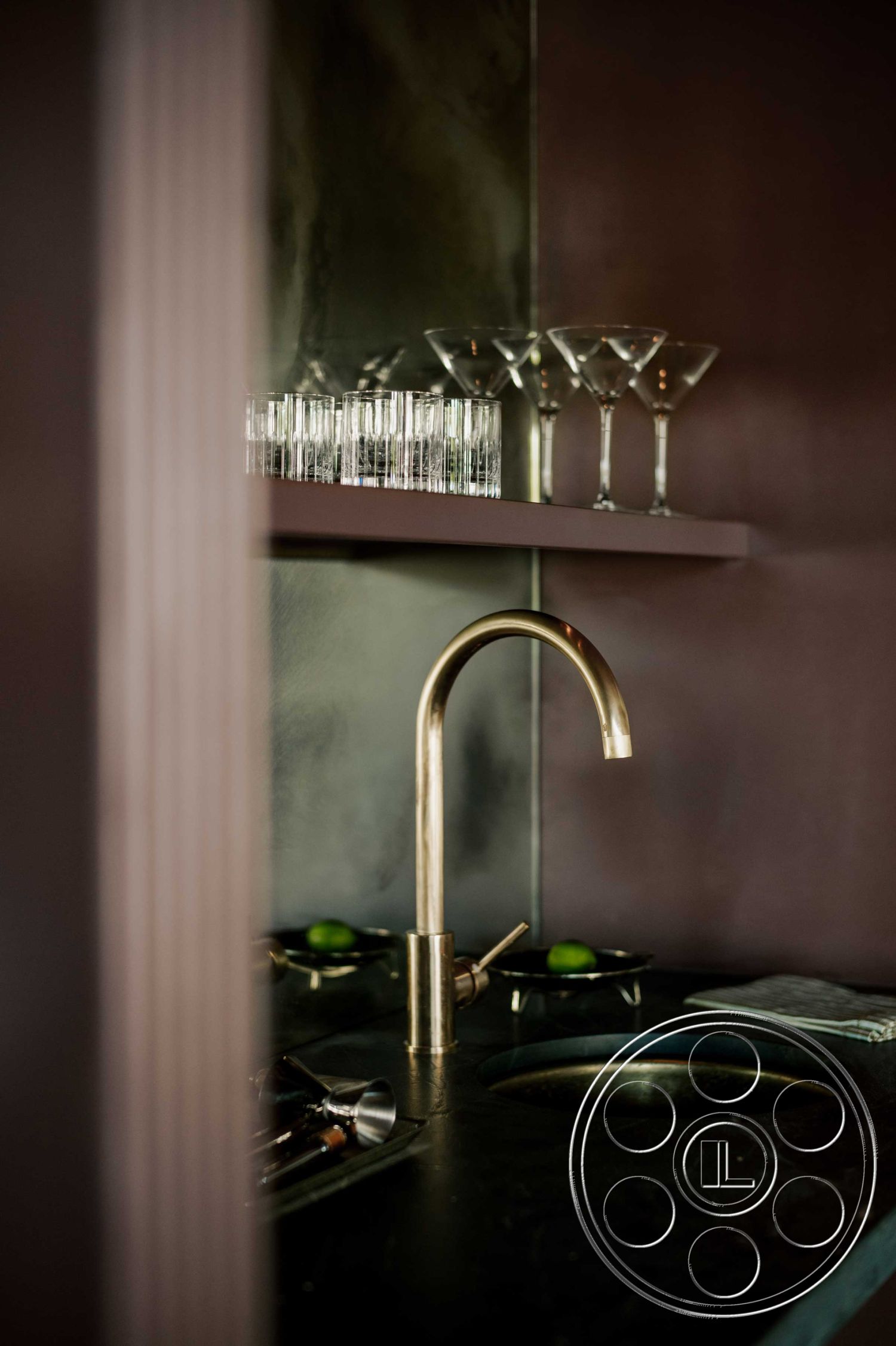 Americana 429 - minimalist decor, black marble countertop, modern design elements, textured wall finish, soft ambient lighting, under-mounted sink, floating shelf, brass faucet, dark painted walls, interior bar area, glass cocktail glasses, luxury home bar, contemporary home interior, hidden cabinet storage, sleek bar tools