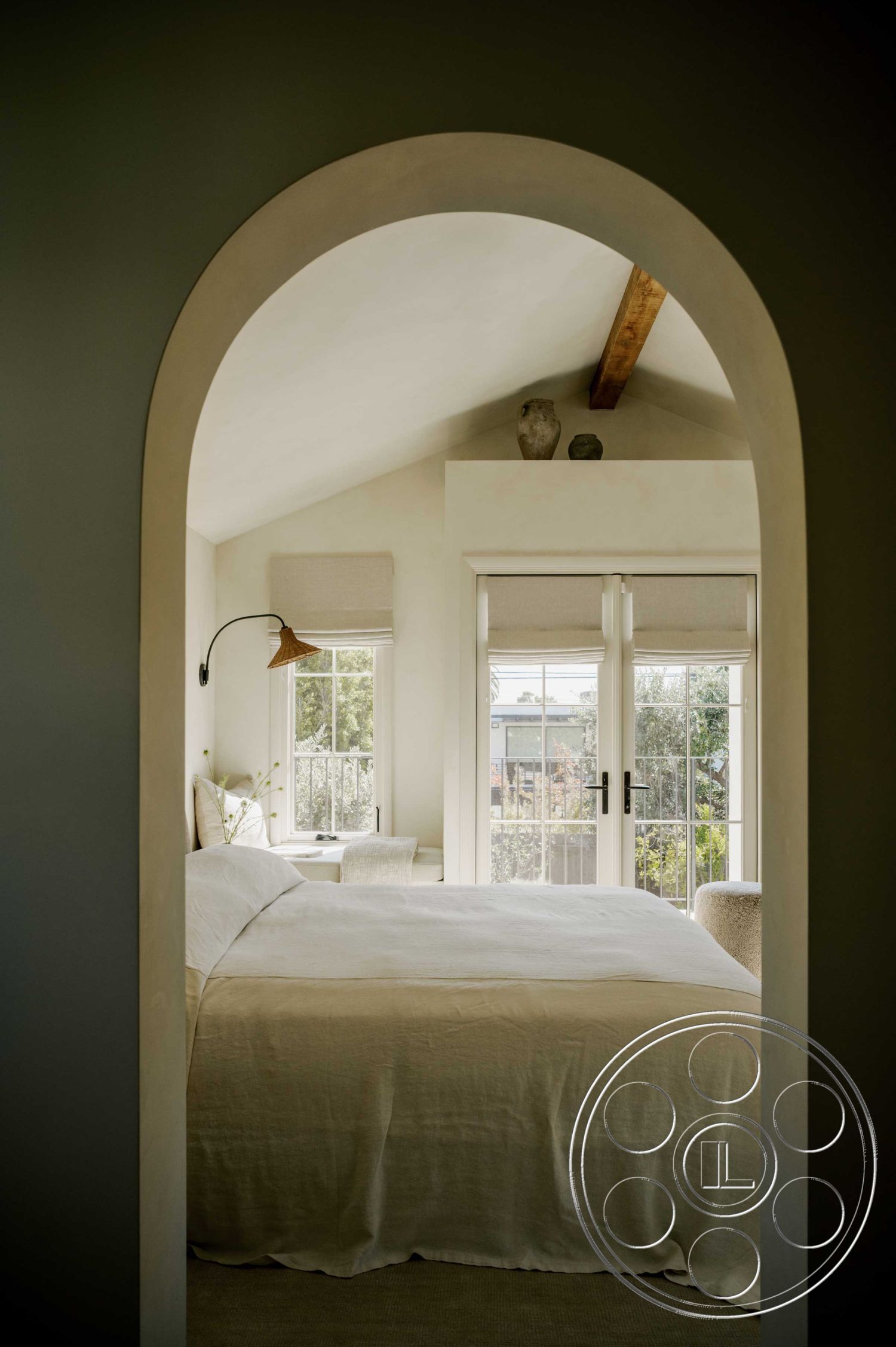 Americana 429 - minimalist decor, floor-to-ceiling windows, textured plaster walls, cozy reading nook, urban garden view, exposed wood ceiling beams, interior bedroom, natural light interior, white painted walls, carpet bedroom flooring, large arched doorway, beige linen bedspread