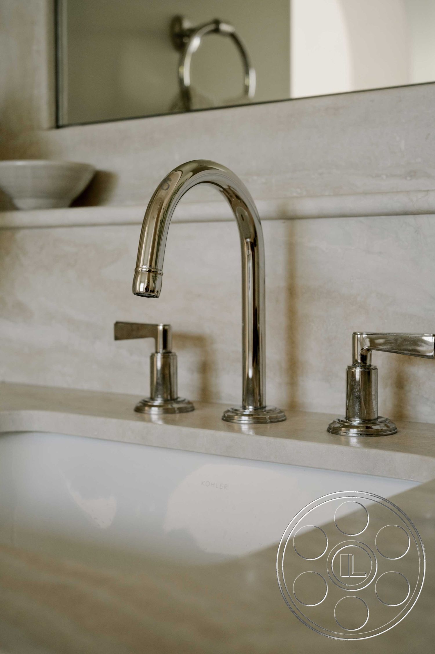 Americana 429 - neutral color palette, textured stone backsplash, single basin sink, chrome faucet fixtures, modern bathroom design, minimalist faucet design, marble bathroom countertop, interior bathroom sink countertop, luxury bathroom details, contemporary bathroom styling