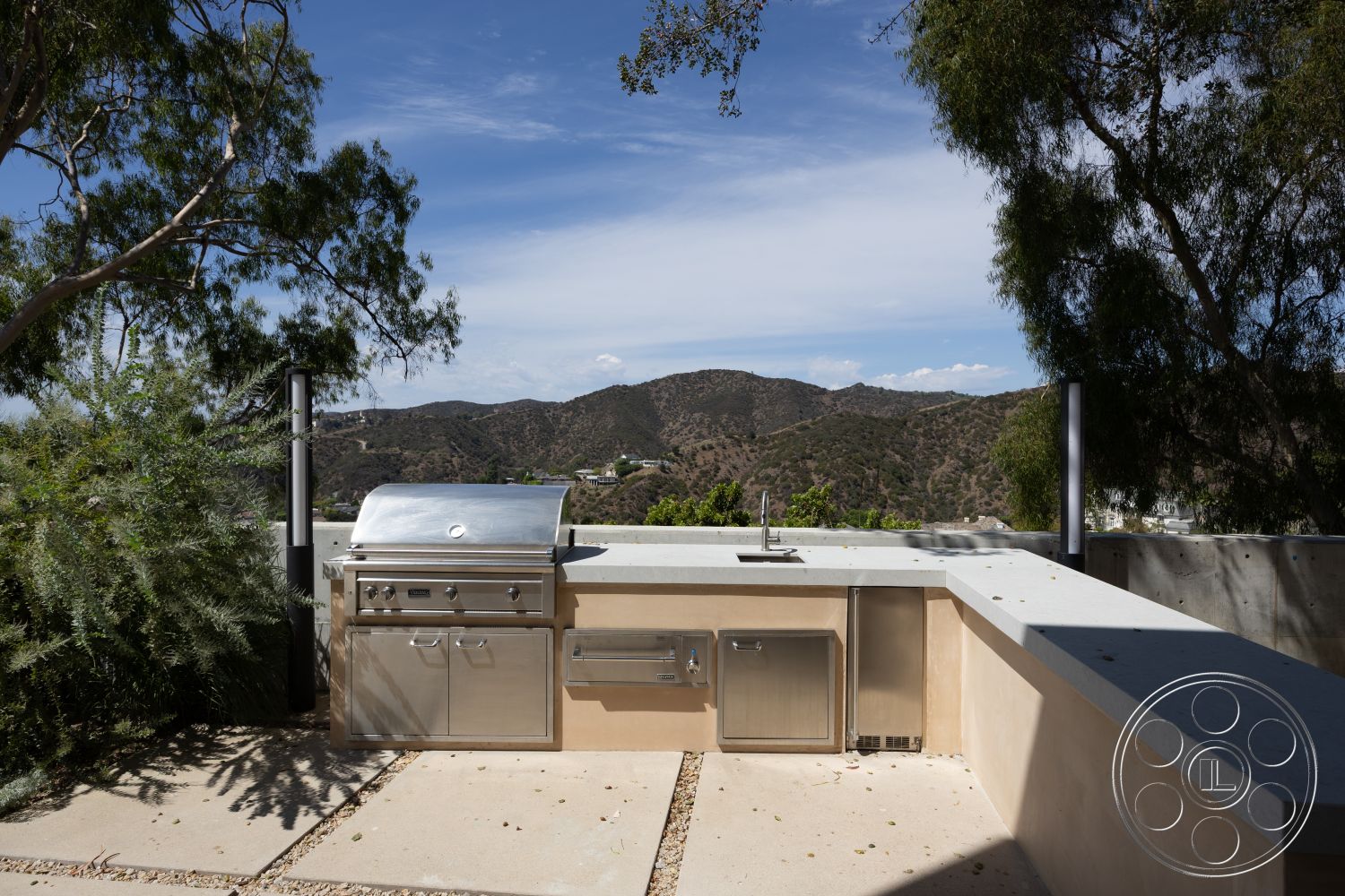 Modern 511 - stainless steel outdoor grill, landscaped hillside setting, smooth concrete patio flooring, concrete countertop outdoor kitchen, stucco walls for outdoor kitchen, mountain view outdoor area, exterior outdoor cooking space, modern outdoor kitchen design, desert environment patio, contemporary grill station
