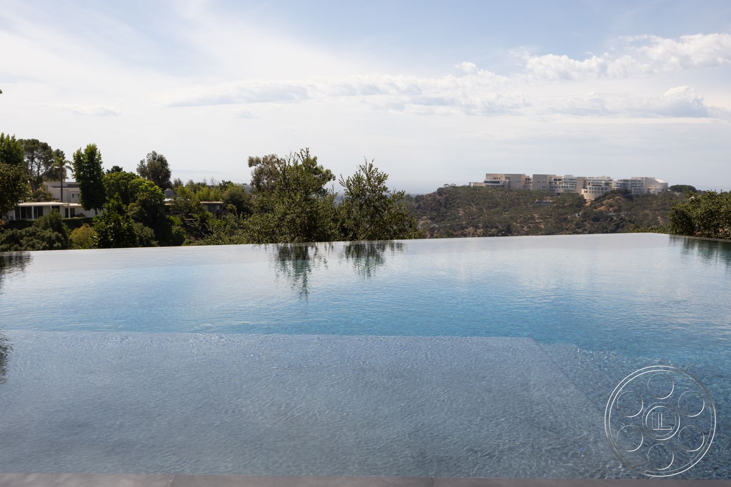 Modern 511 - infinity pool, concrete pool deck, lush greenery backdrop, outdoor swimming pool, modern outdoor design, urban hillside view, landscaped garden surroundings, glass tile pool edge, luxury residential setting, sun-soaked exterior, exterior relaxation area, panoramic cityscape view