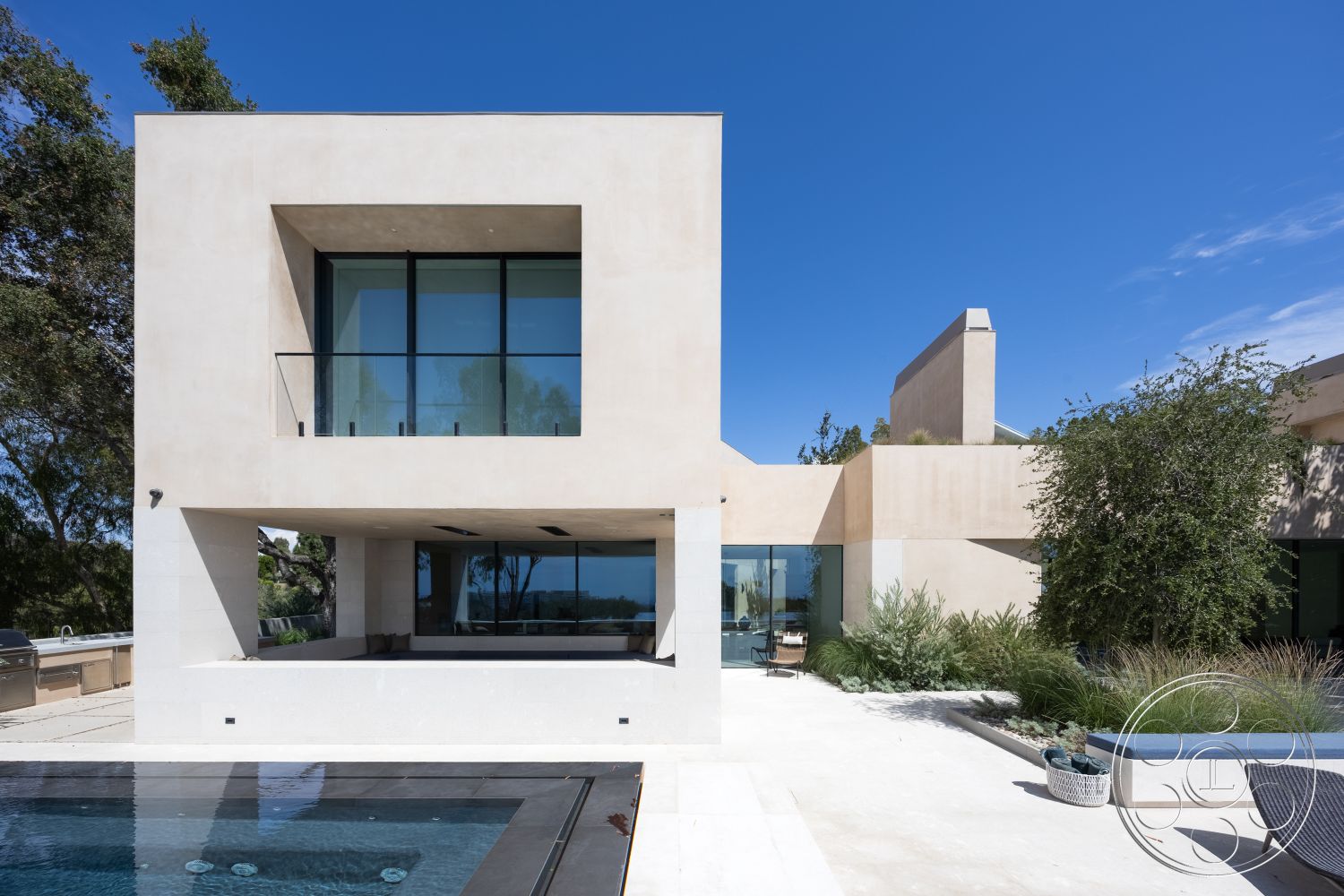 Modern 511 - minimalist design elements, outdoor lounge area, modern architectural style, rectangular pool, flat roof design, open floor plan layout, concrete pool border, exterior concrete walls, glass floor-to-ceiling windows, natural stone patio flooring, sunny hillside location, white stucco exterior finish, built-in outdoor seating, landscape with drought-resistant plants, clean geometric lines, balcony with glass railing, poolside entertaining area