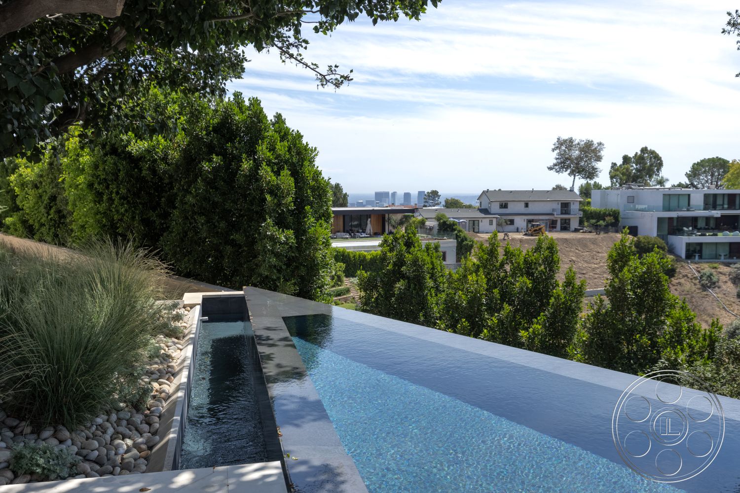 Modern 511 - minimalist design elements, horizontal wood fencing, outdoor living area, integrated outdoor lighting, landscaped garden patio, lush greenery landscaping, urban hillside view, suburban hillside location, concrete pool surround, infinity pool edge, glass pool barrier, natural stone landscaping gravel, modern concrete retaining wall, exterior of contemporary home, slaughter pathway, steel edging, breathtaking ocean view, seamless pool transition, modern outdoor architecture