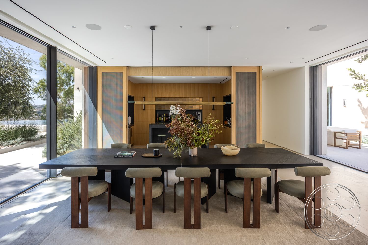 Modern 511 - neutral color palette, open floor plan, contemporary interior design, interior dining room, minimalist kitchen design, floor-to-ceiling glass sliding doors, natural light ambiance, clean lines and geometric shapes, suburban garden view, wooden dining chairs with upholstered seats, black polished concrete dining table, light wood cabinetry in kitchen, textured fabric chair upholstery, suspended modern light fixture, backlit cabinetry, soft area rug under dining table