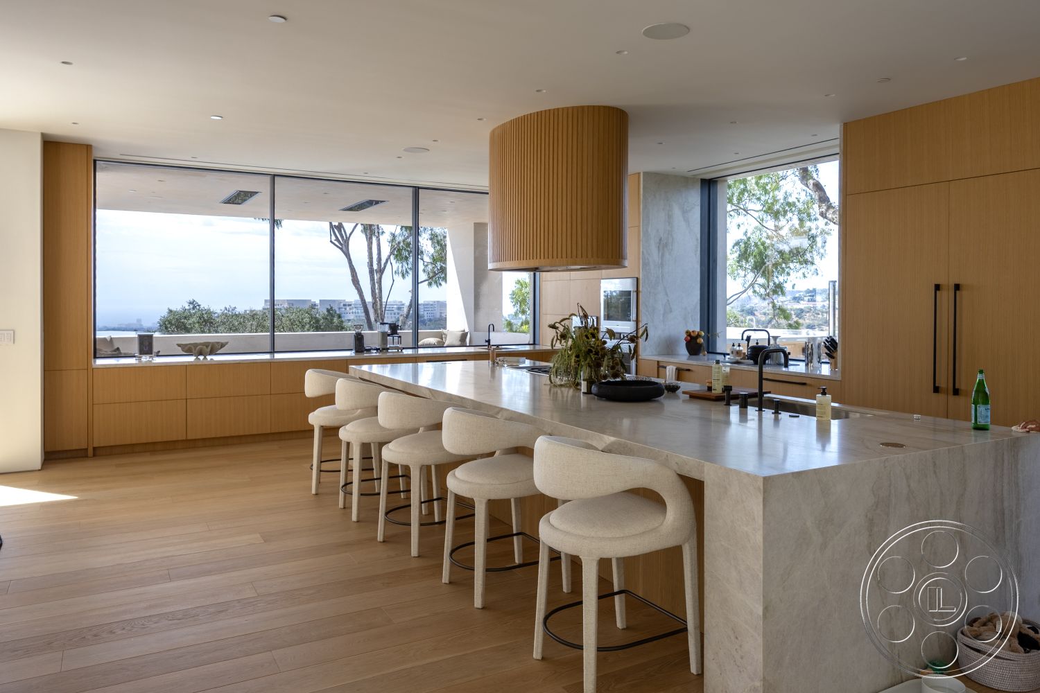 Modern 511 - minimalist design, open concept layout, glass sliding doors, light wood cabinetry, floor-to-ceiling windows, textured wall treatments, circular pendant light, interior kitchen, hardwood kitchen floors, marble countertop island, natural light filled space, modern ergonomic bar stools, contemporary kitchen decor, elevated city skyline view, integrated appliance design, sleek black kitchen fixtures, natural wood accent details