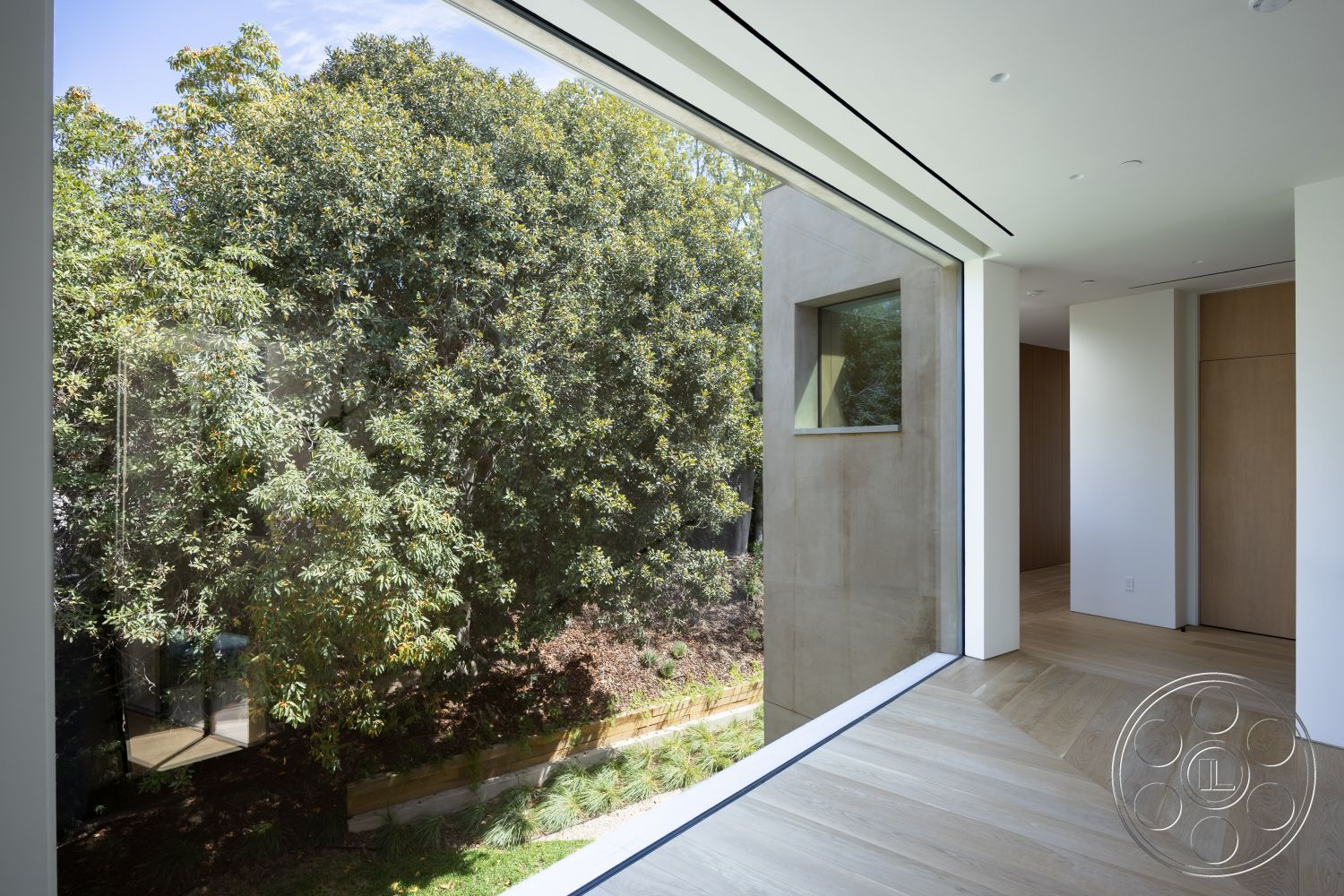 Modern 511 - interior recessed ceiling lighting, interior minimalistic design, interior open floor plan, exterior landscaped garden view, interior wood plank flooring, exterior large glass windows, interior natural light emphasis, interior smooth concrete walls, interior modern wood door, exterior framed window, exterior greenery reflection, interior sleek architectural lines