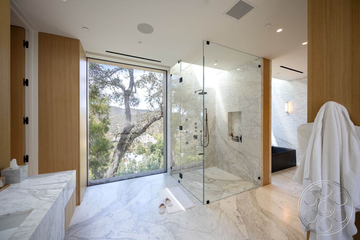 Modern 511 - interior floor-to-ceiling windows, interior natural wood paneling, interior recessed lighting details, interior marble shower walls, interior wooden cabinetry, interior marble bathroom flooring, interior wall-mounted glass shower doors, interior mountain view setting, interior minimalist bathtub, interior modern vanity with marble countertop, interior brushed metal fixtures