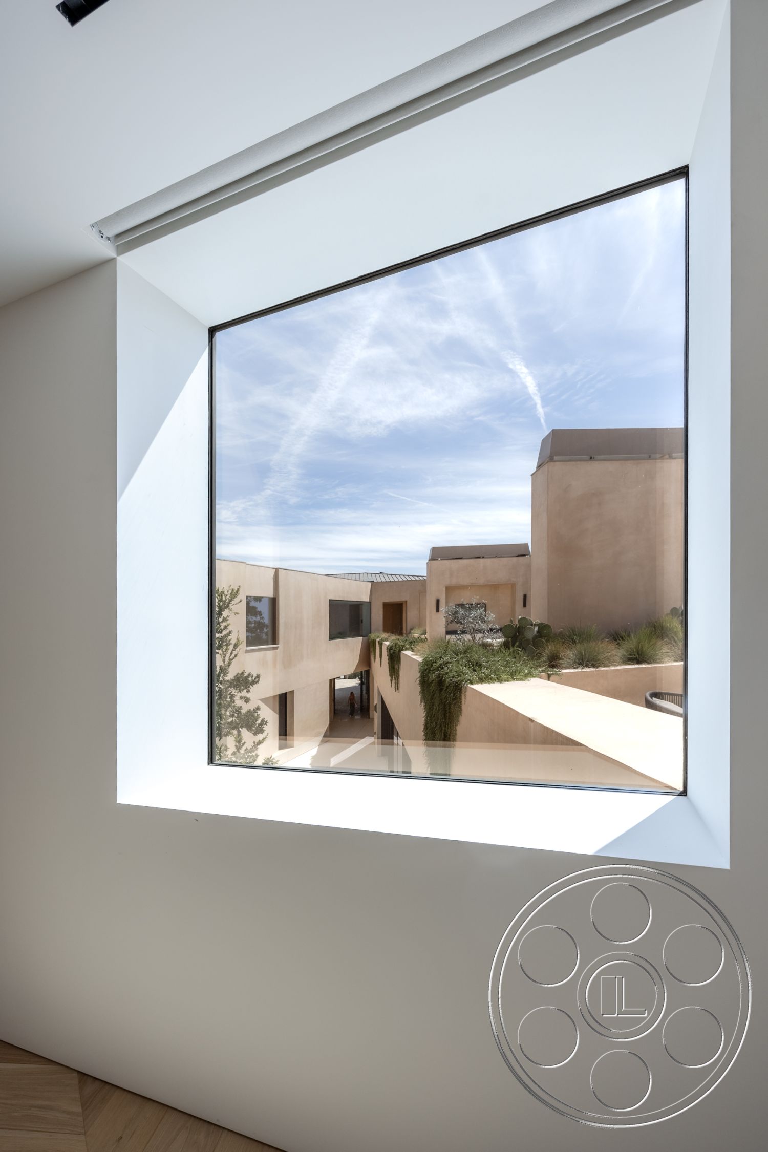 Modern 511 - light wood flooring, outdoor landscaping, sustainable building materials, large rectangular window, natural light interior, modern architectural details, minimalist design style, plaster interior walls, smooth white wall surface, angular exterior design, courtyard with greenery, contemporary house, open air view, skyline visual perspective, sculptural landscaping features